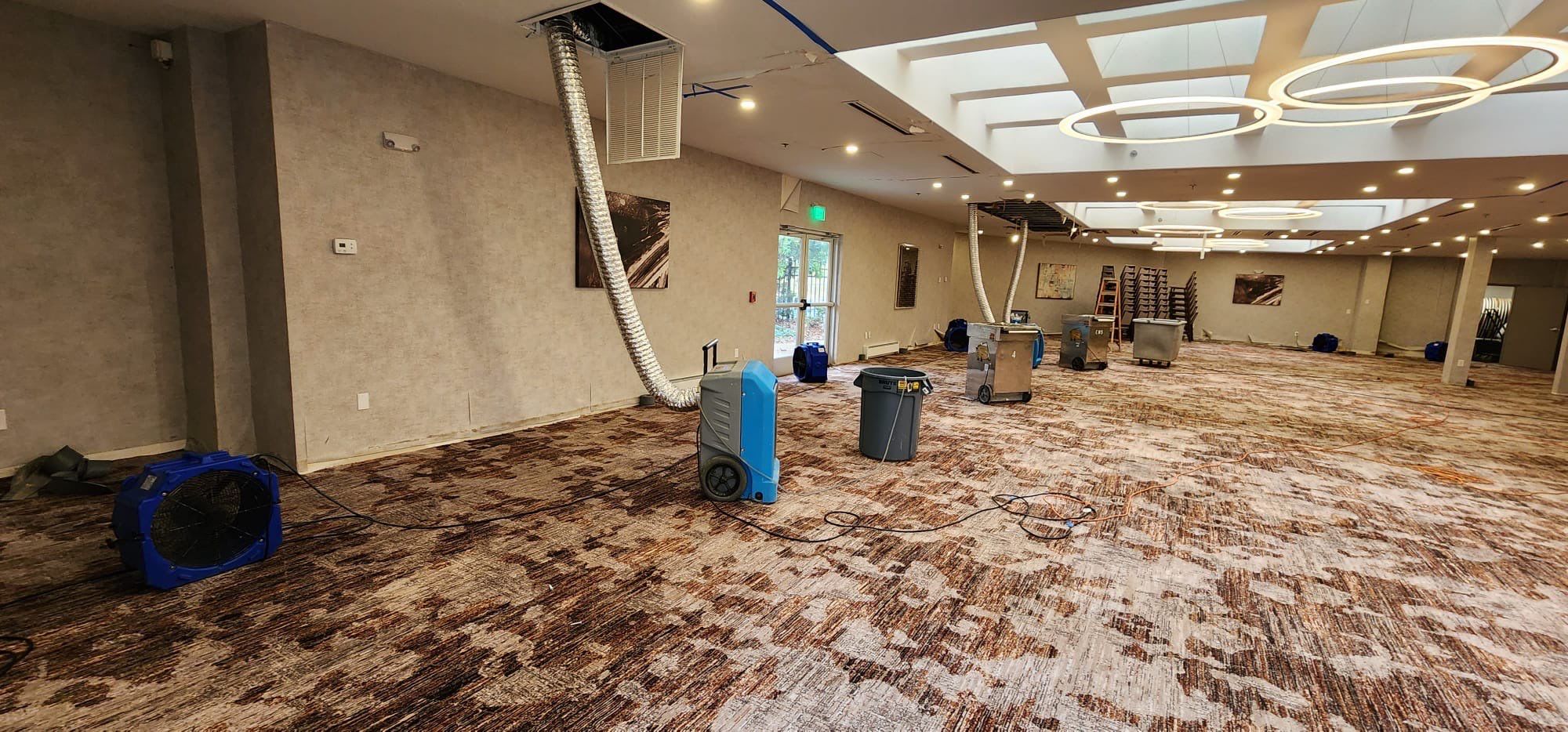 Structural drying in progress with moisture-removal equipment deployed throughout affected area.