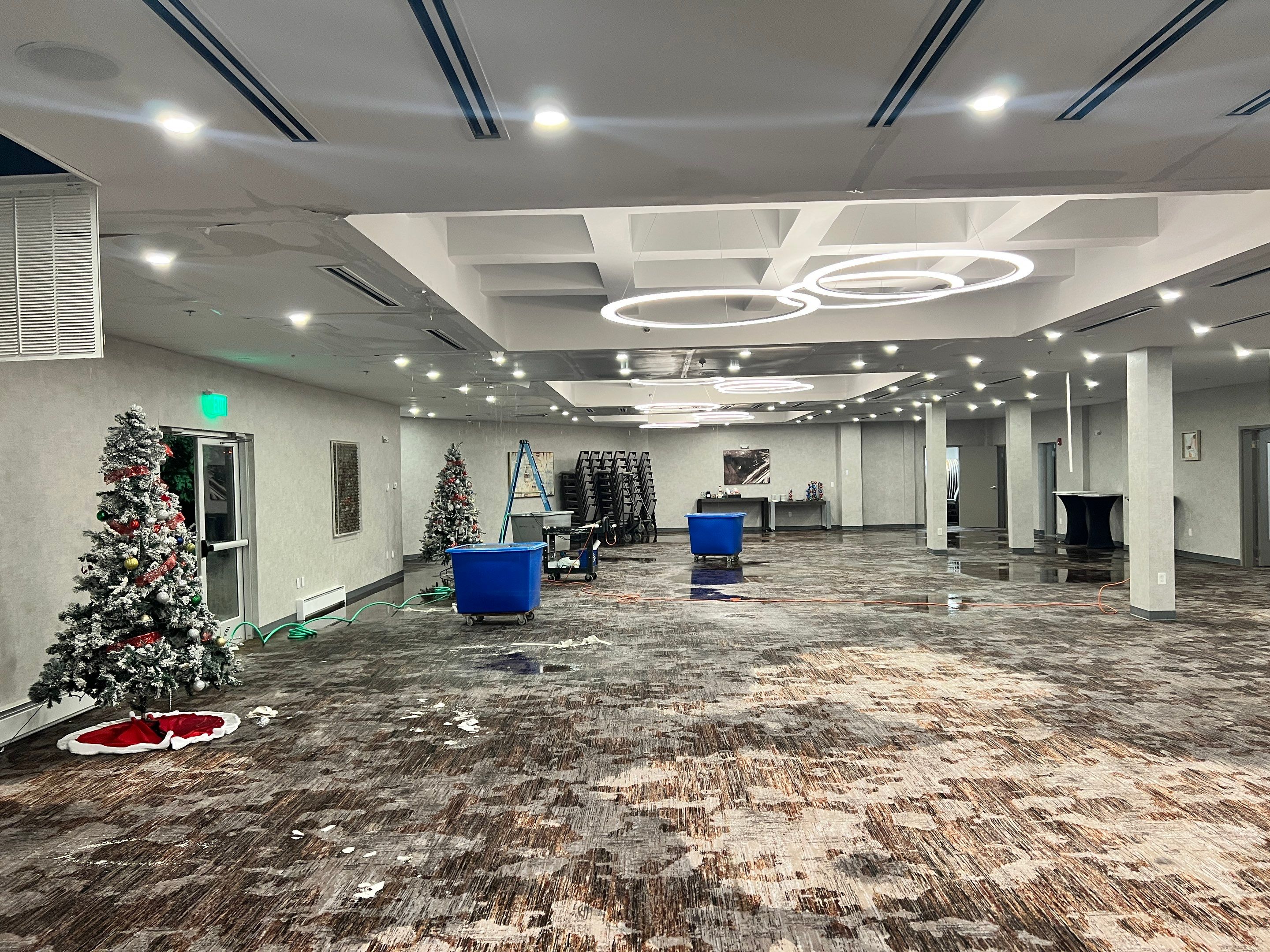 Dehumidification equipment positioned during mid-stage drying of water-damaged interior space.