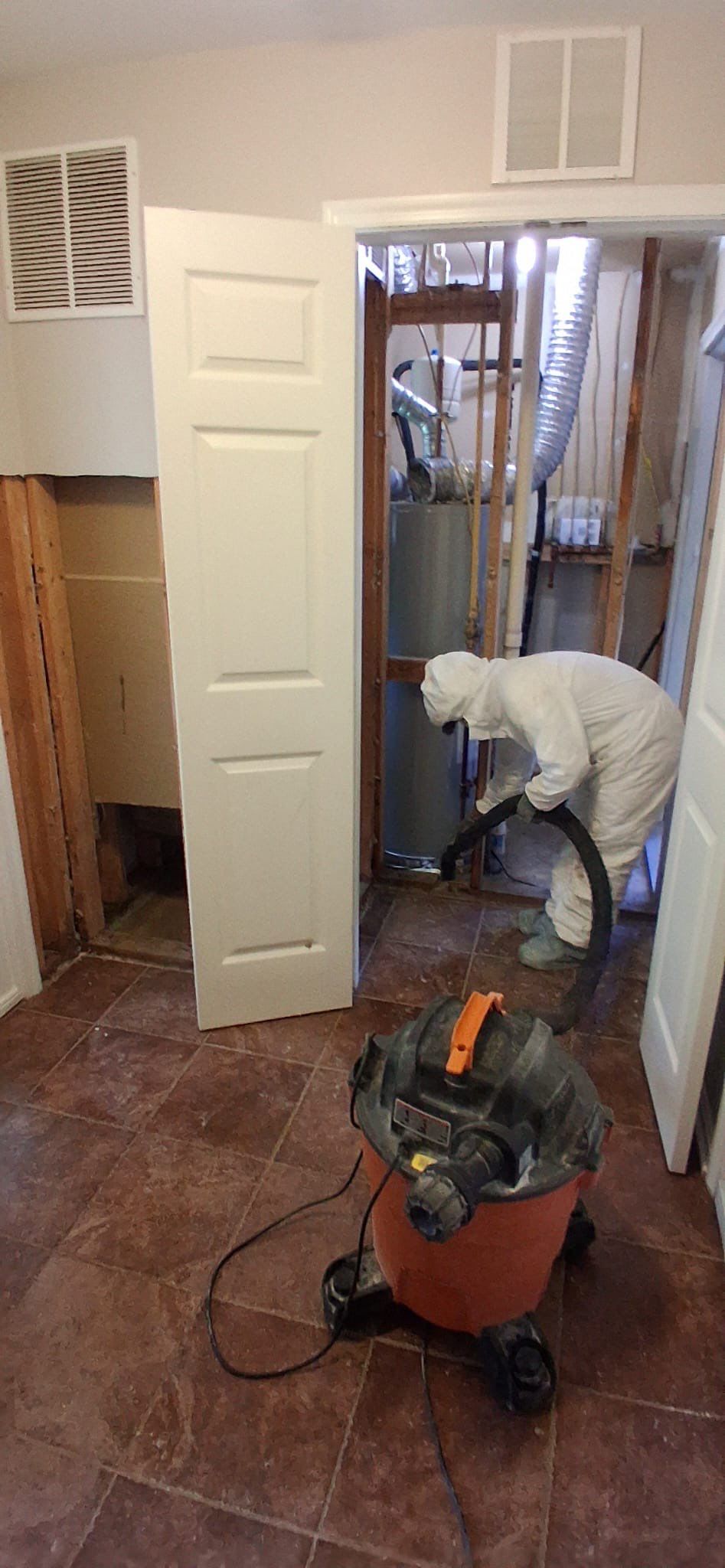 Water damage from tank leak pooling on flooring in Fairfax home before extraction and drying begins.