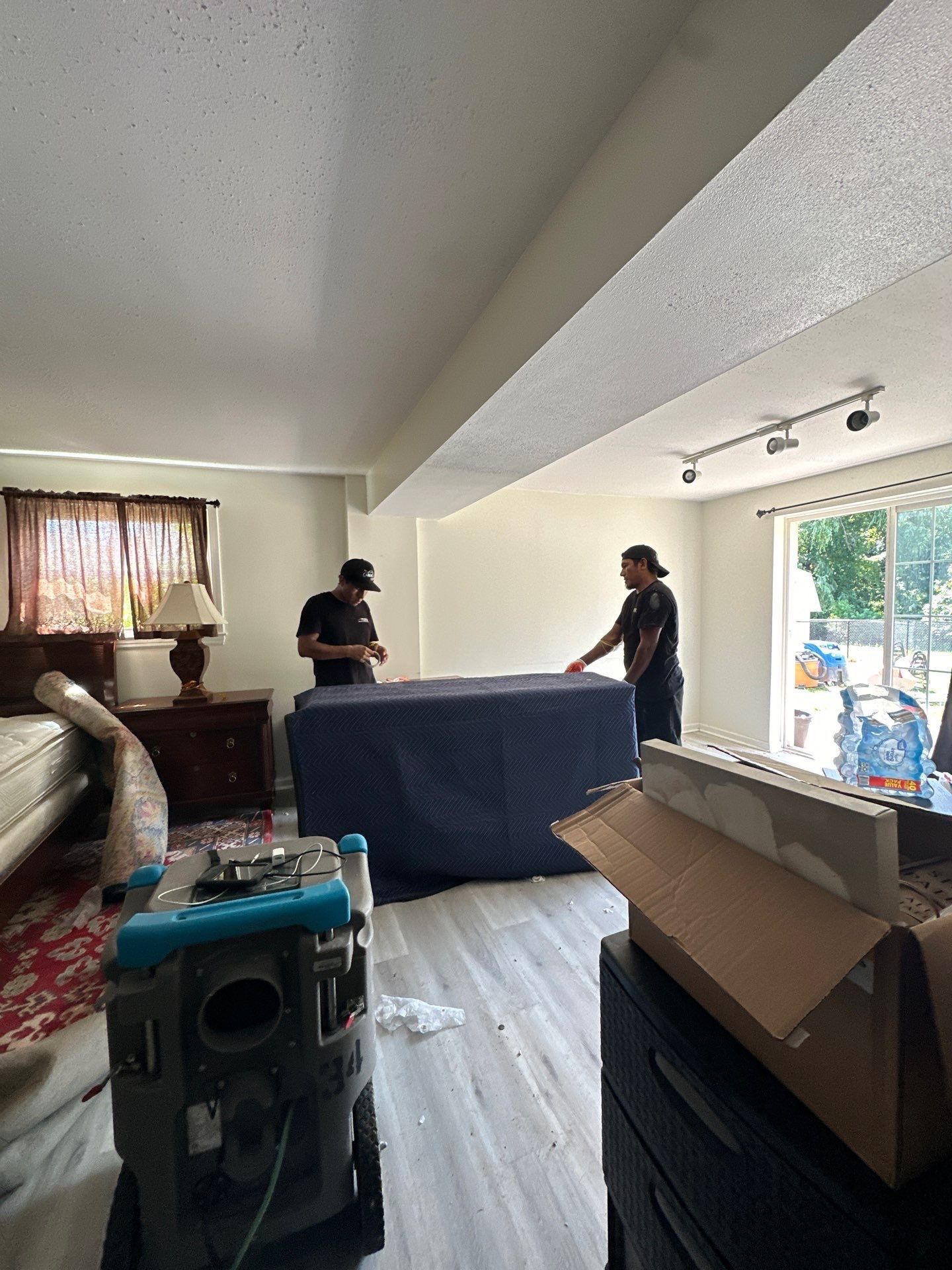 Carpet and flooring remediation underway as part of water damage restoration sequence.