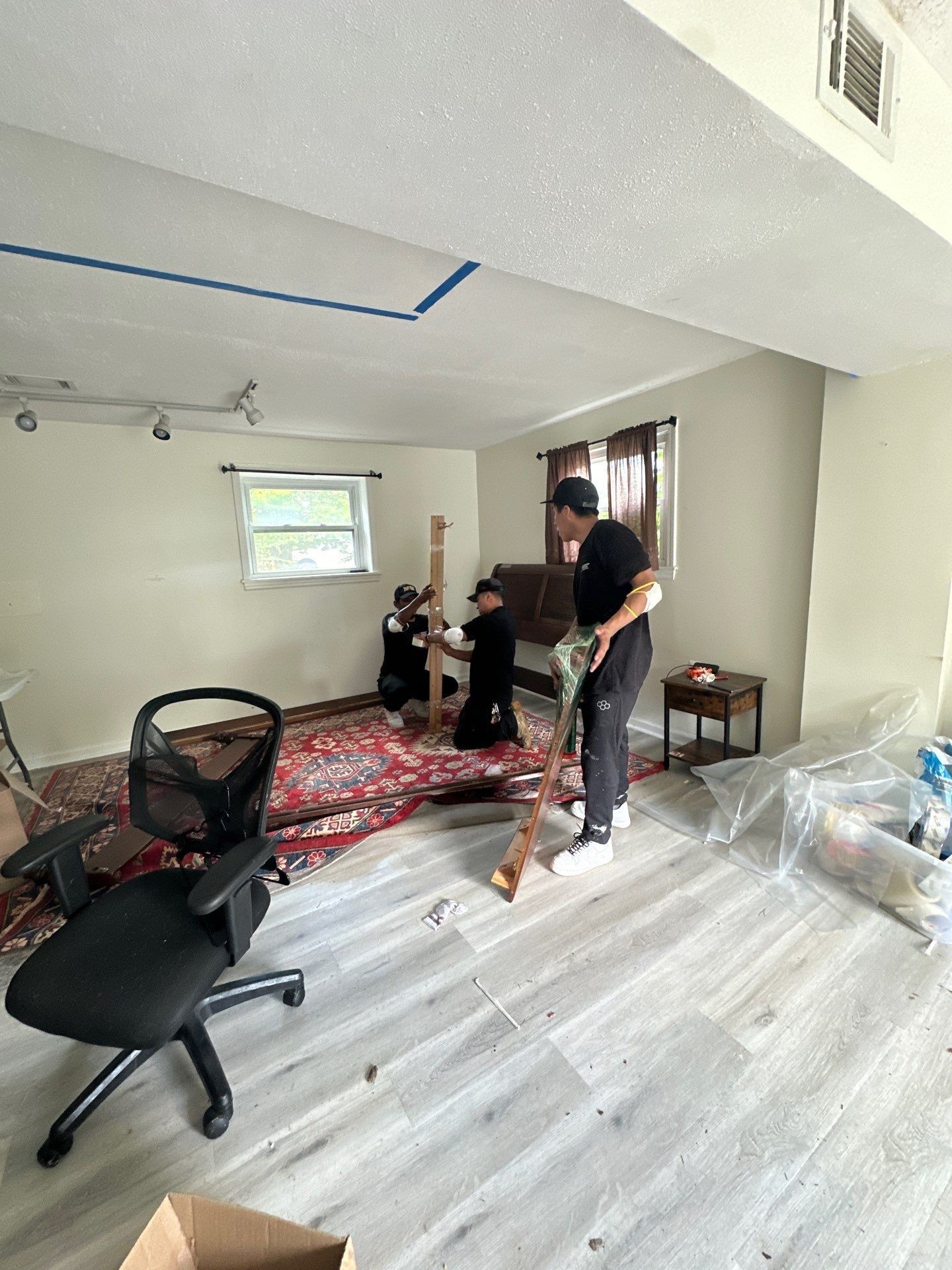 Structural drying in progress with dehumidifiers and air movers positioned throughout affected areas.
