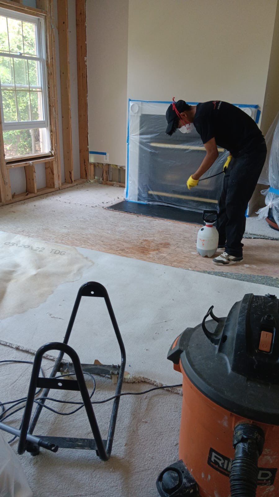 Standing water extraction underway in Arlington water damage restoration, dehumidifiers positioned for structural drying.