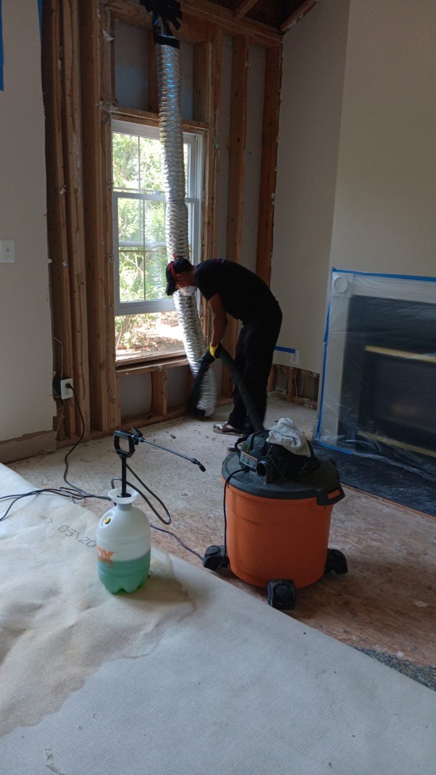 Structural drying in progress with positioned dehumidification and extraction equipment monitoring moisture levels.