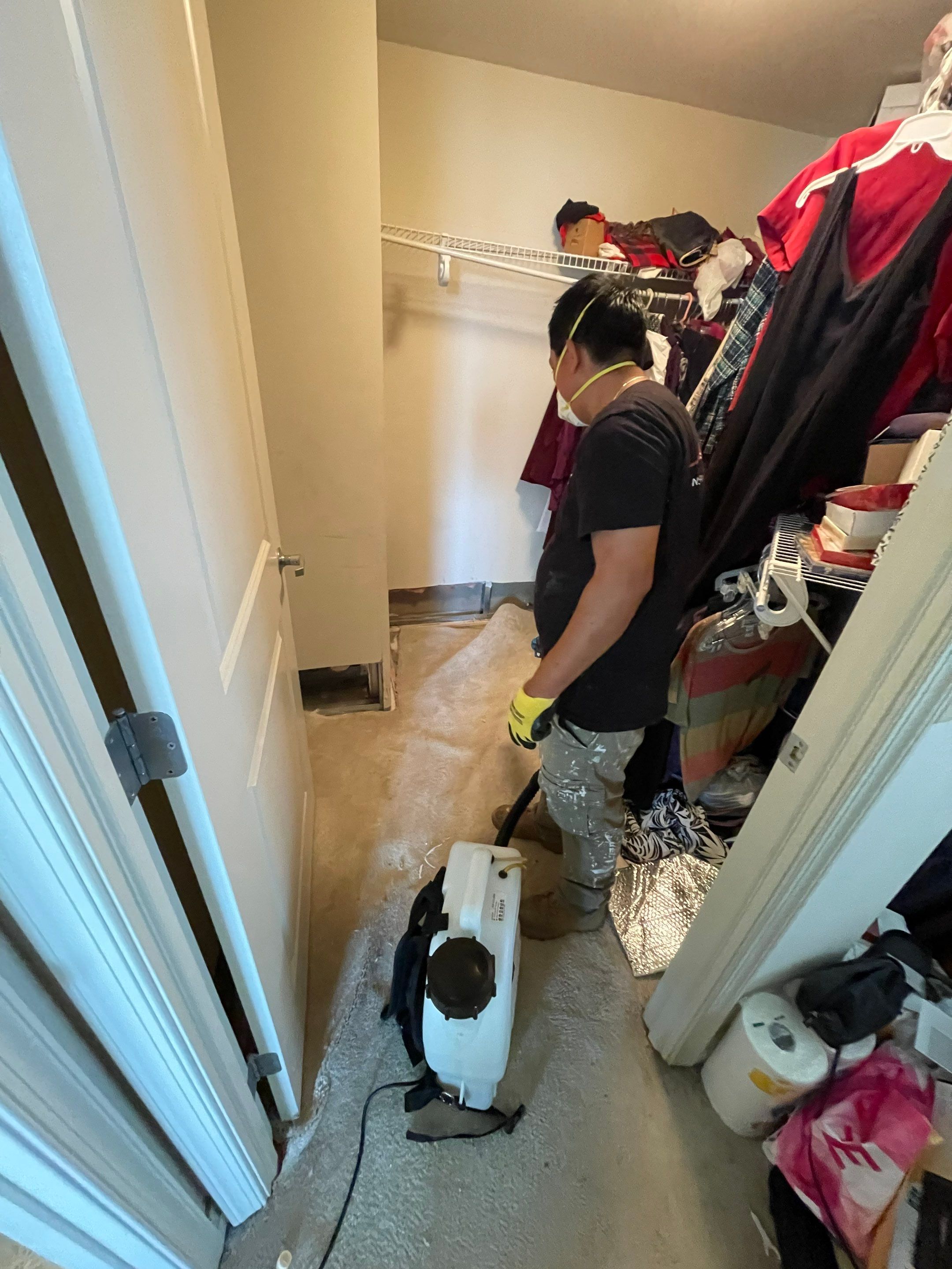 Standing water extraction underway in Reston water damage restoration, removal phase beginning.