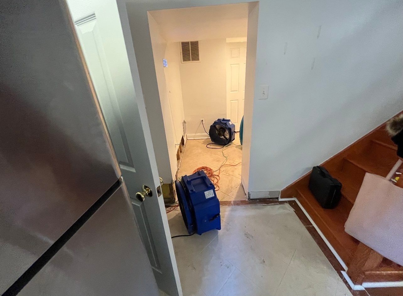 Mid-stage water removal and dehumidification equipment deployed across affected area during restoration work.
