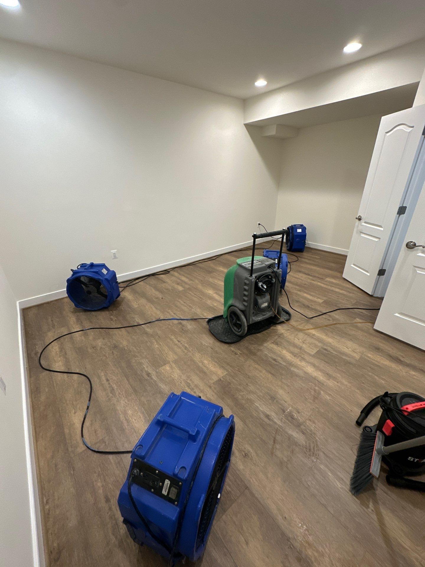 Sanitizing application to affected surfaces as part of water damage remediation.