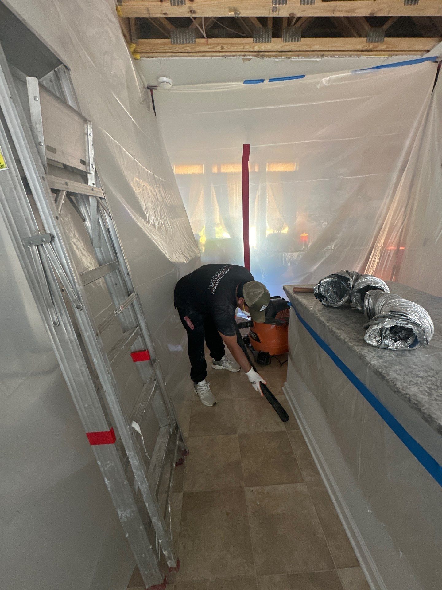 Dehumidification unit operating within containment during mid-stage drying phase of Ashburn water restoration.