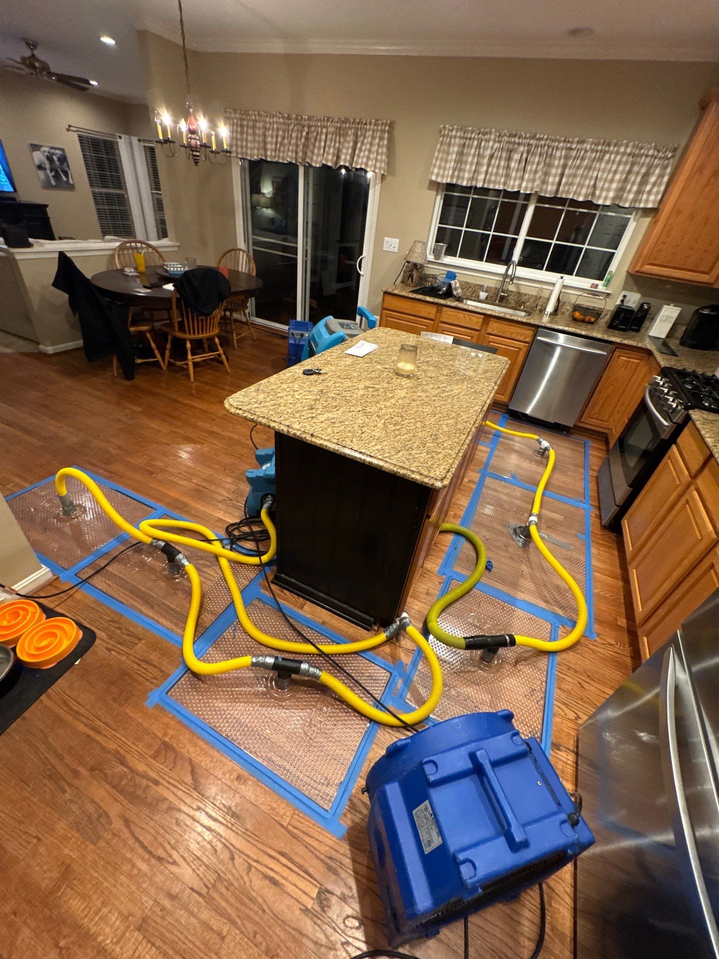 Water damage restoration in Linton Hall: wet carpet and flooring with drying equipment positioned for structural moisture removal.