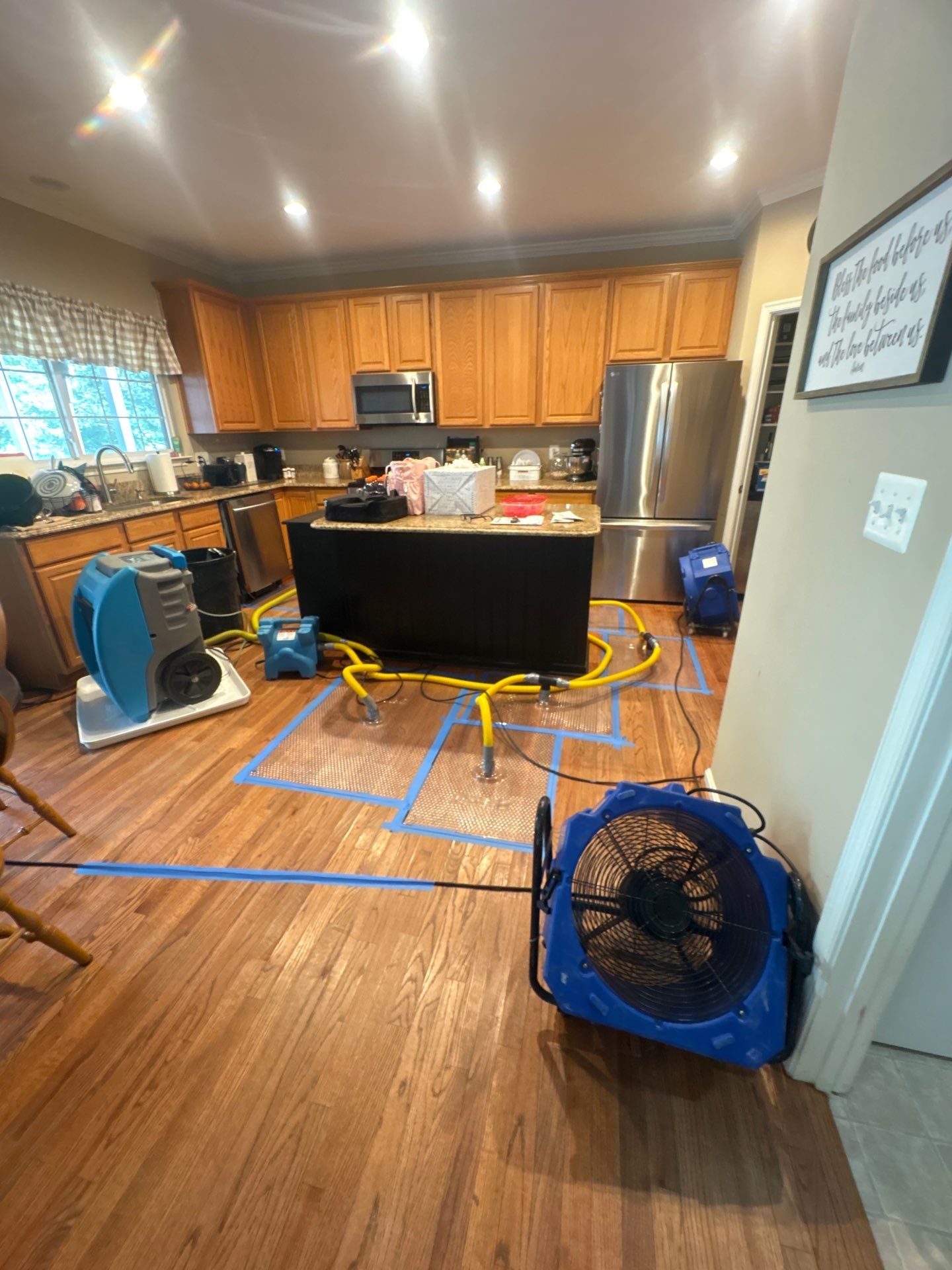 Continued structural drying with equipment placement optimized for air circulation across damaged carpet and subfloor areas.
