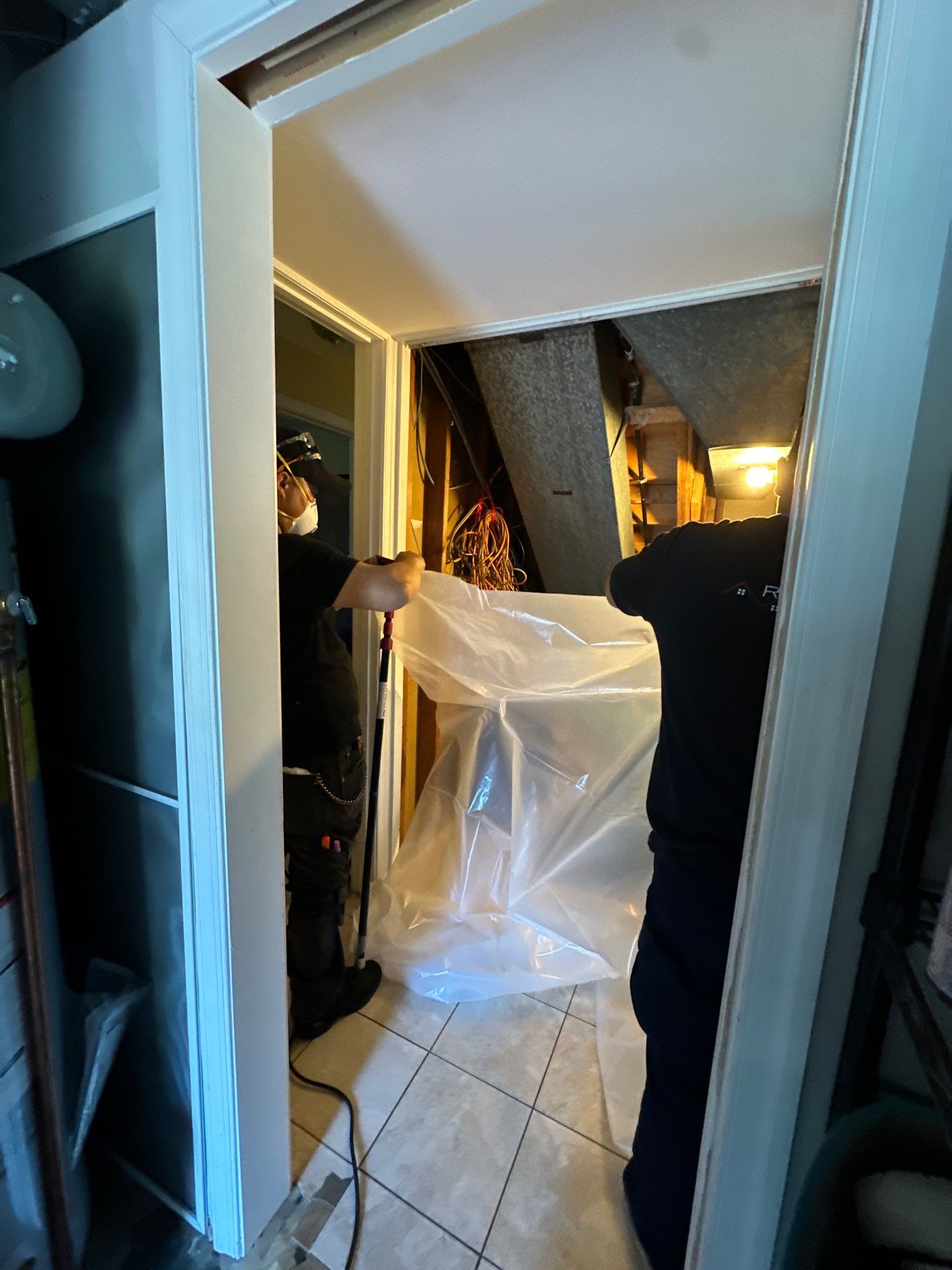 Structural drying in progress with multiple dehumidifiers and air movers working to extract moisture from walls and flooring.