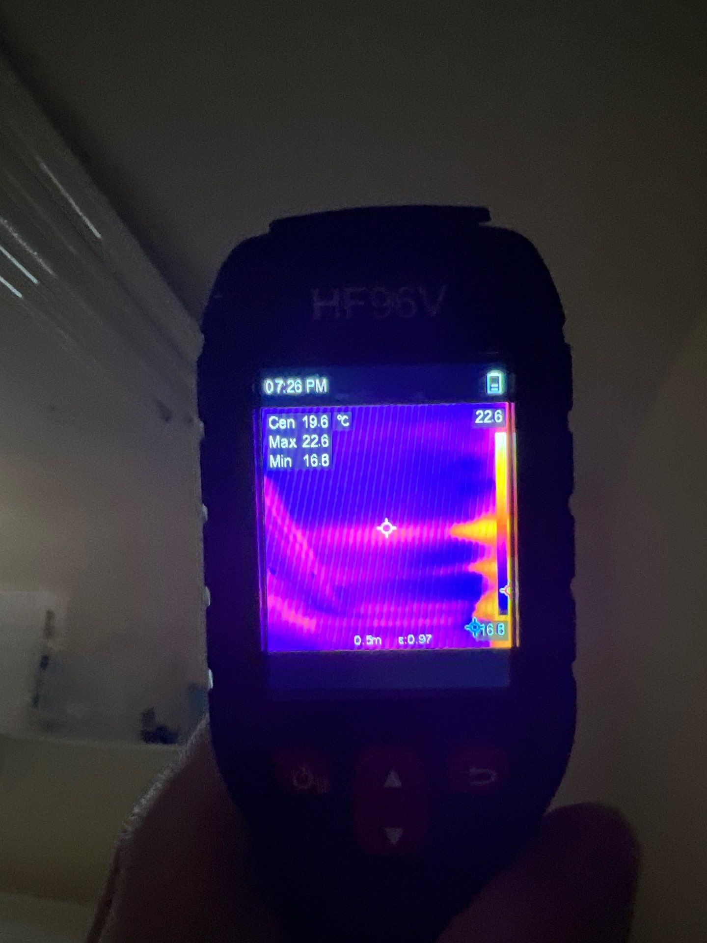 Thermal imaging camera detecting moisture patterns in drywall during water damage assessment in Reston.