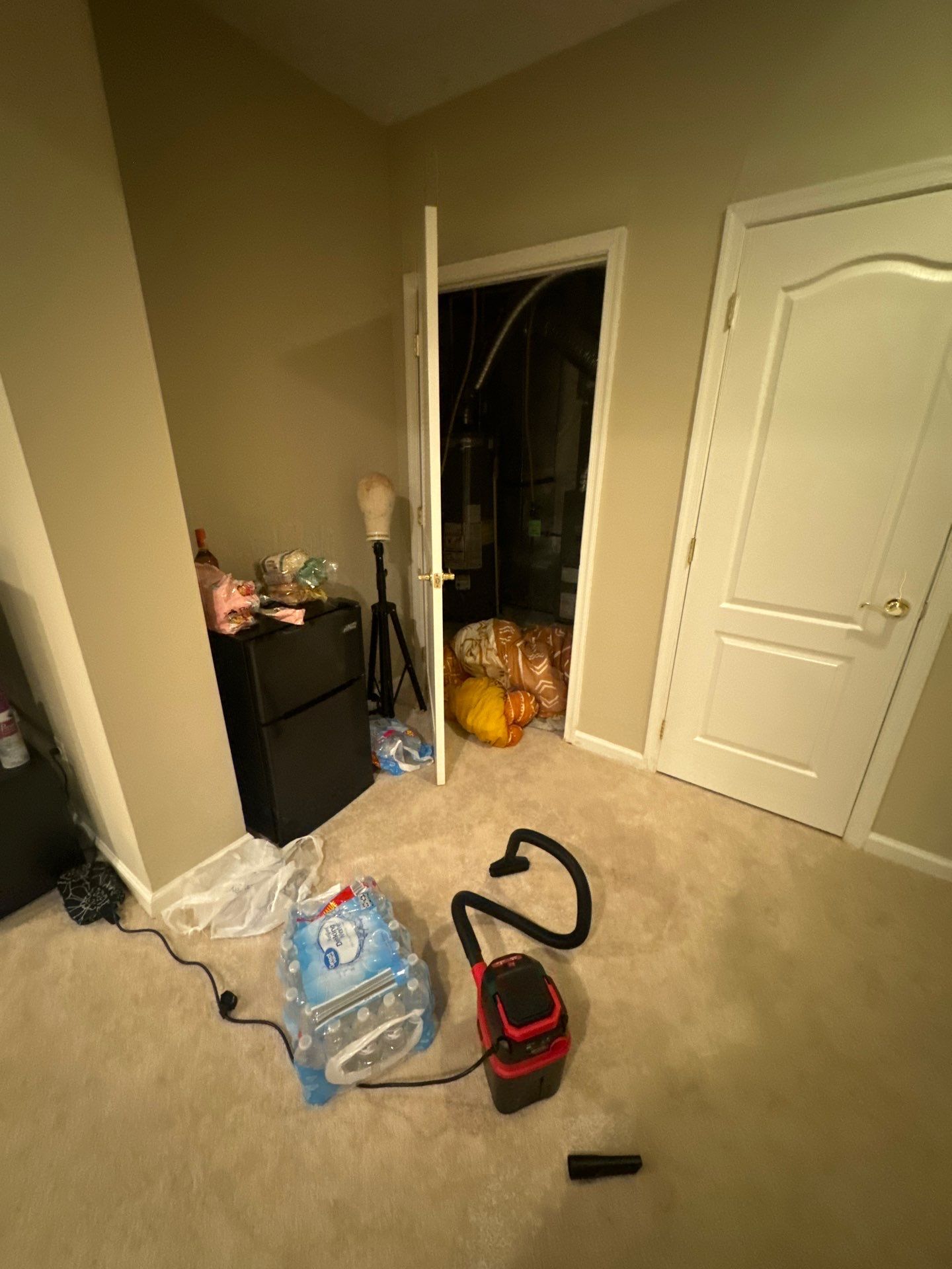 Water damage assessment in Alexandria bathroom showing initial flooding and saturation of flooring and wall base.