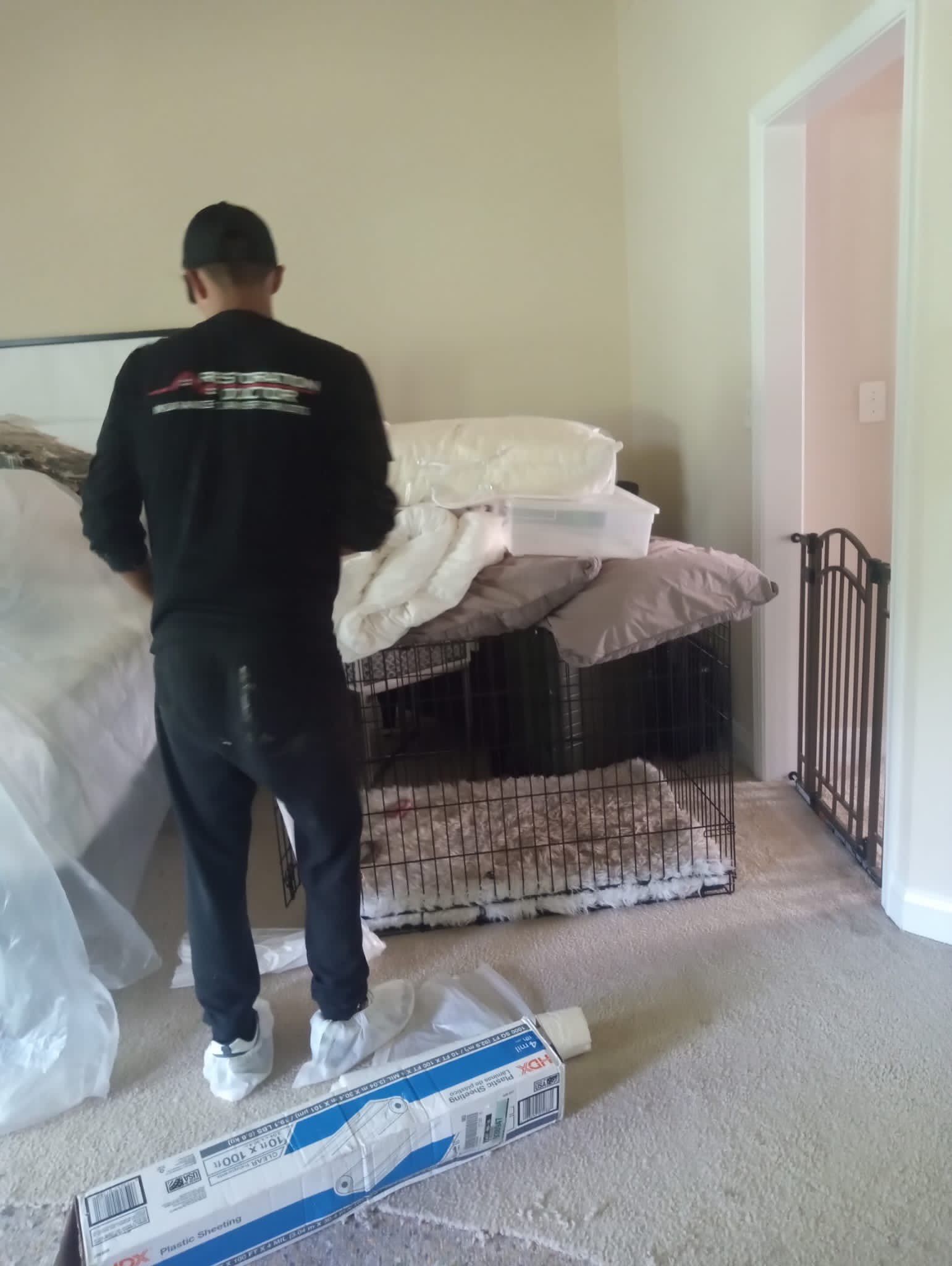 Water-damaged flooring and carpet in Arlington home with drying equipment positioned for structural moisture removal.