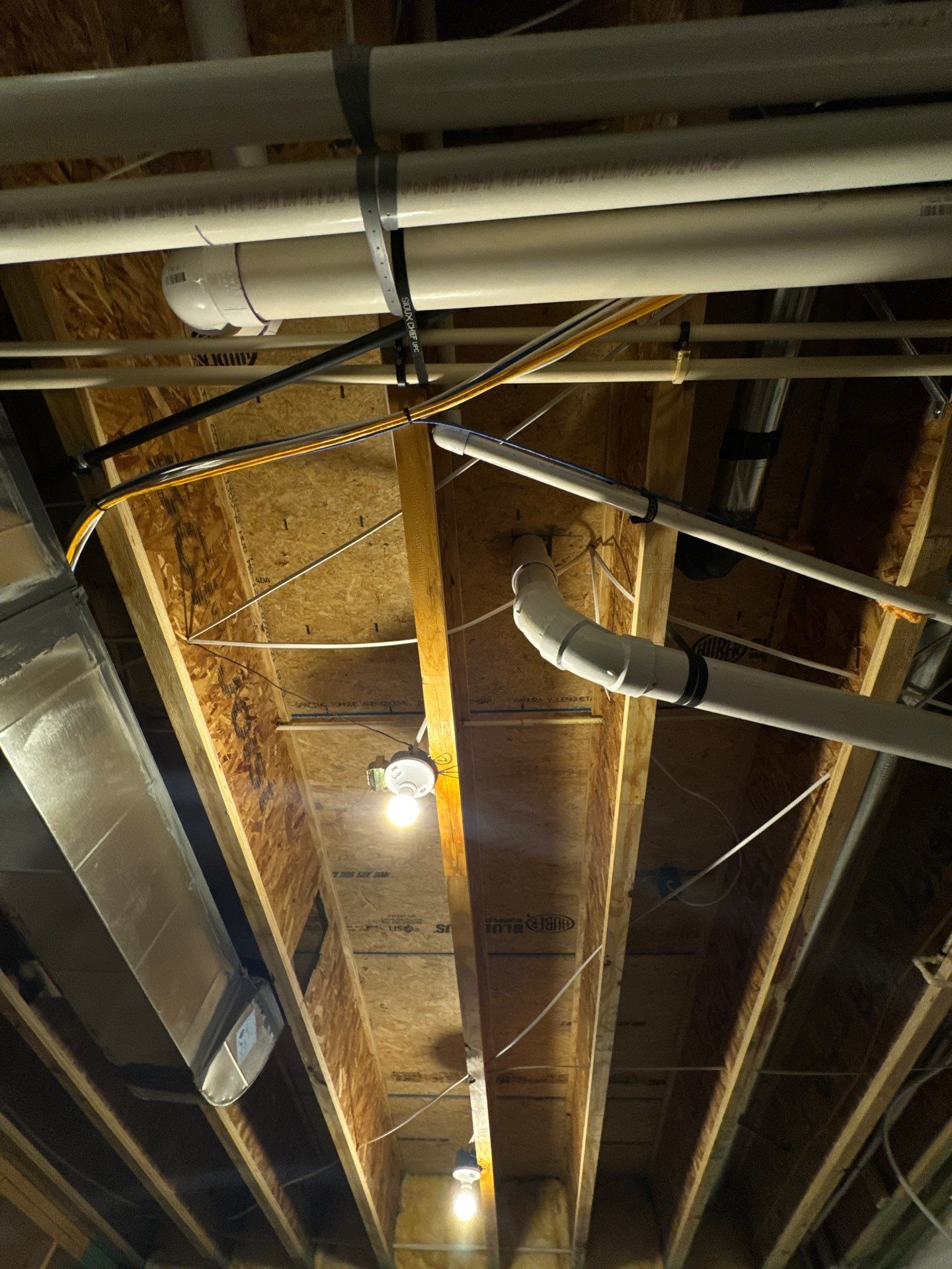 Removal of contaminated drywall and framing exposing moisture source in ceiling assembly.