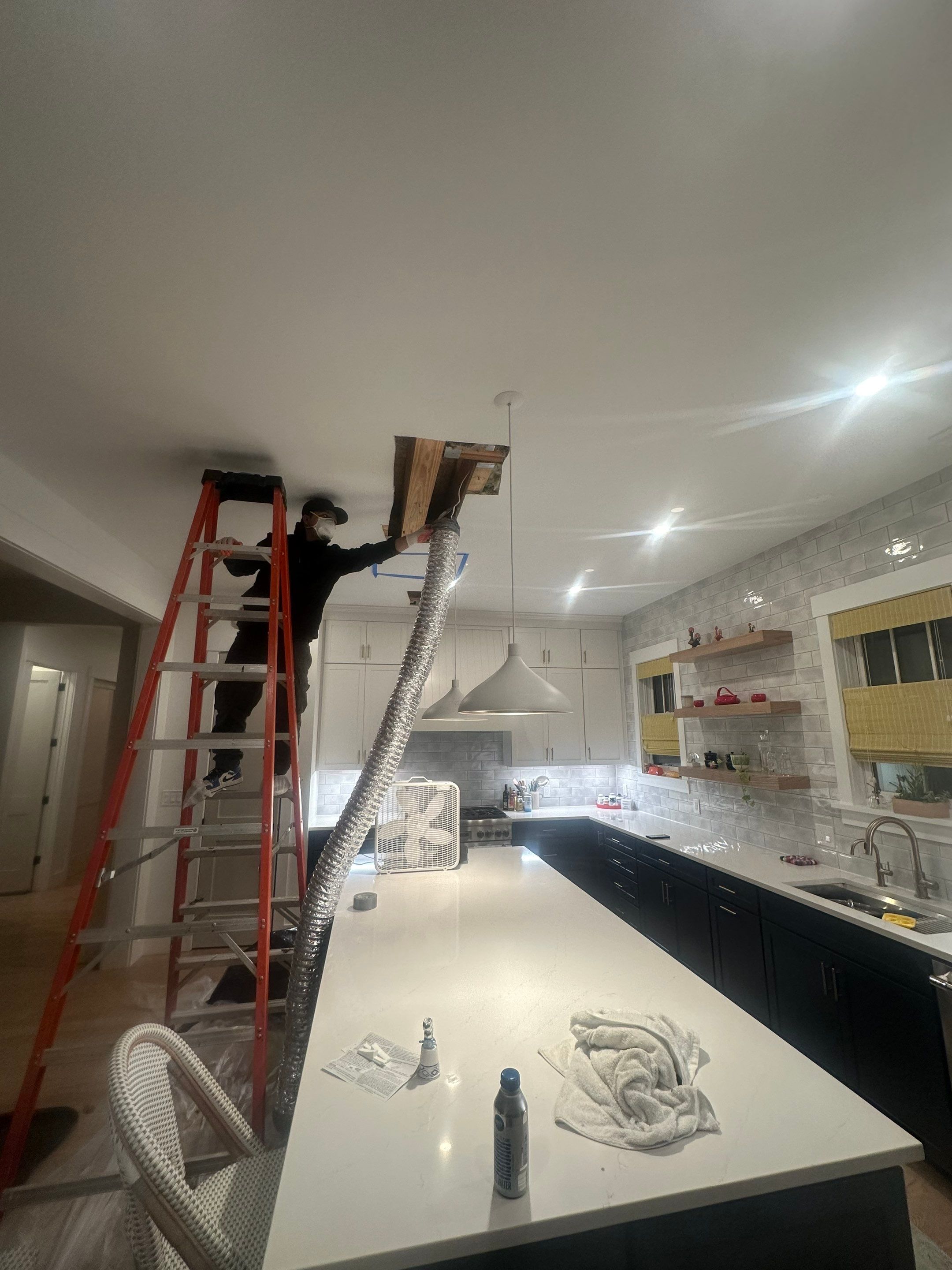 Thermal imaging camera detecting moisture patterns in ceiling cavity during inspection.