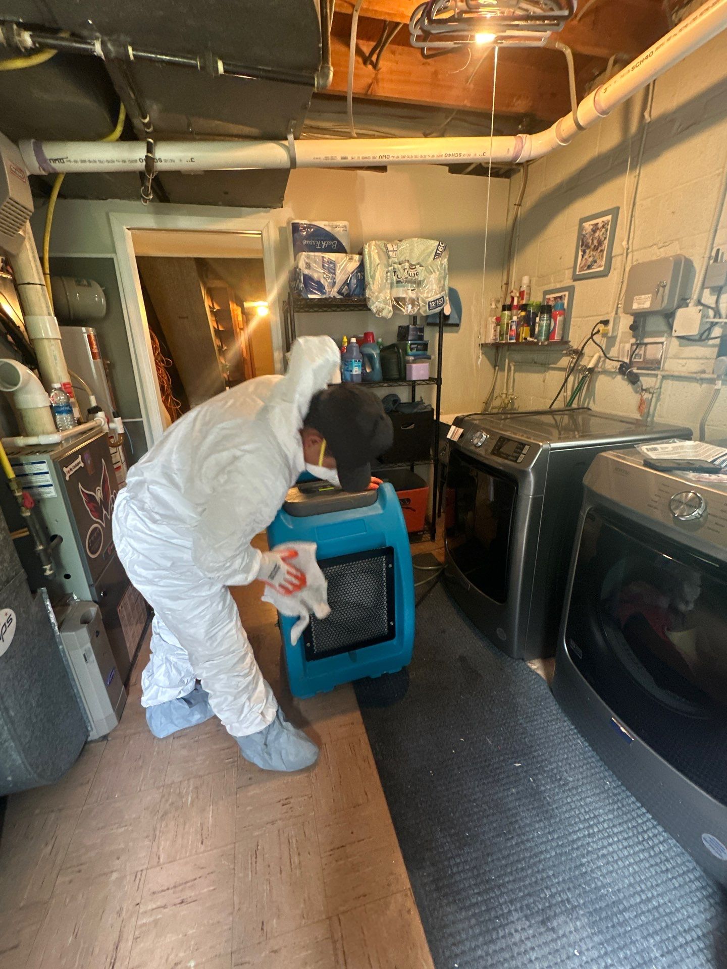 Final-stage water damage restoration in Alexandria with sanitizing and equipment removal as drying cycle nears completion.