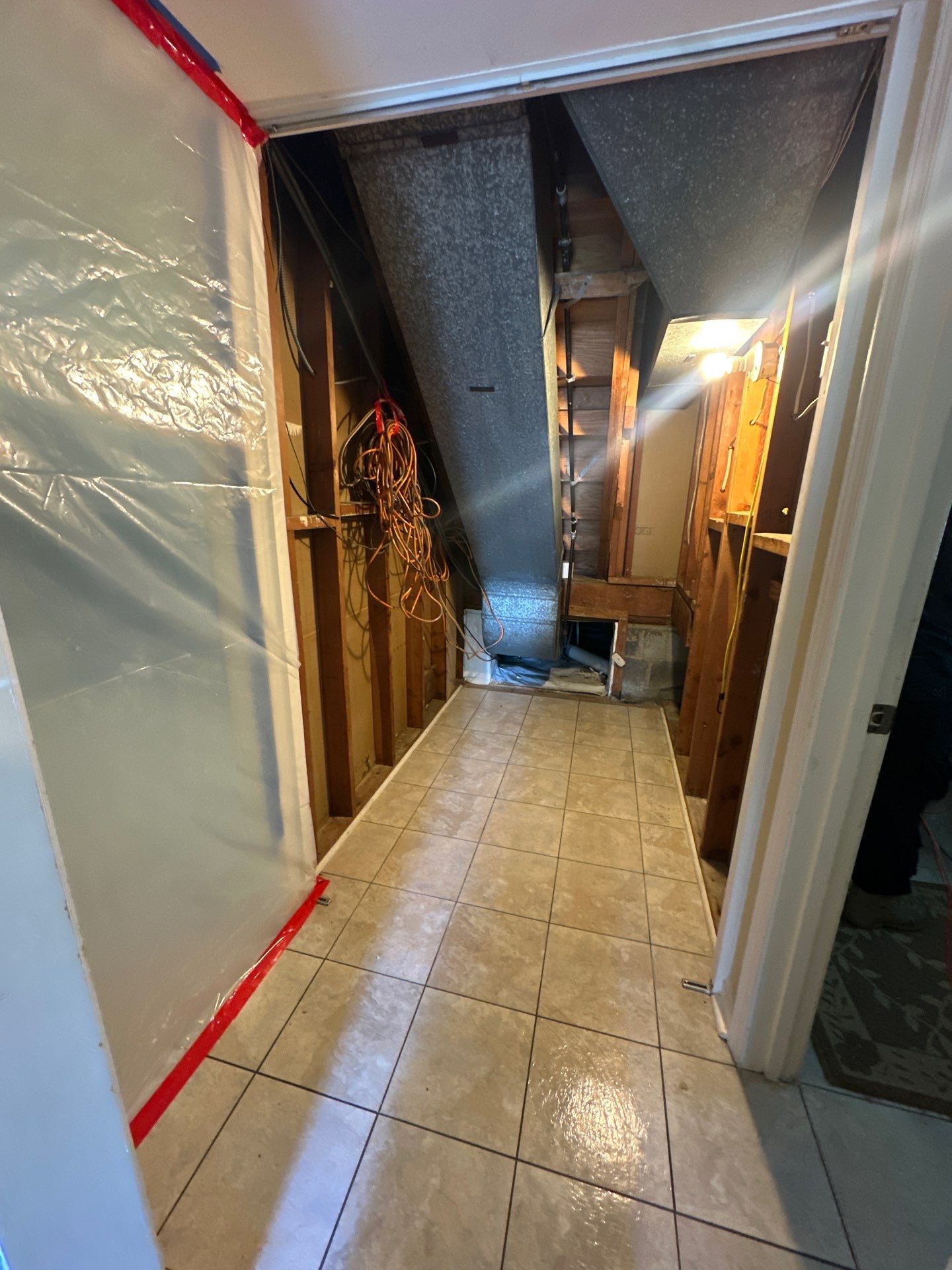 Structural drying in progress with multiple dehumidifiers extracting moisture from walls and flooring in Alexandria water damage job.