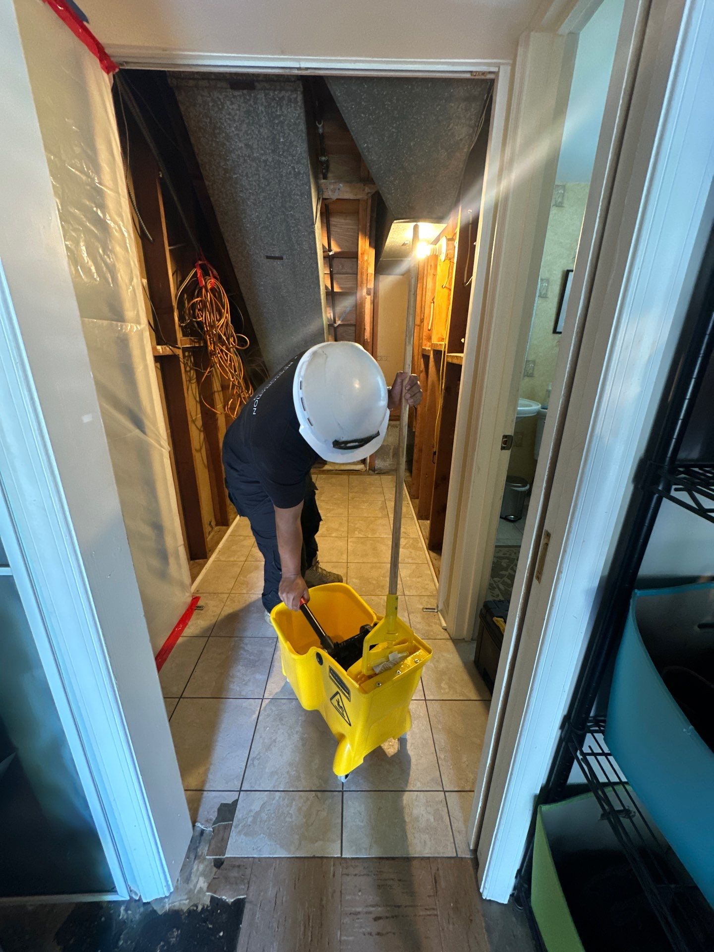 Mid-stage drying operation showing dehumidification equipment monitoring moisture levels across affected areas of Alexandria home.