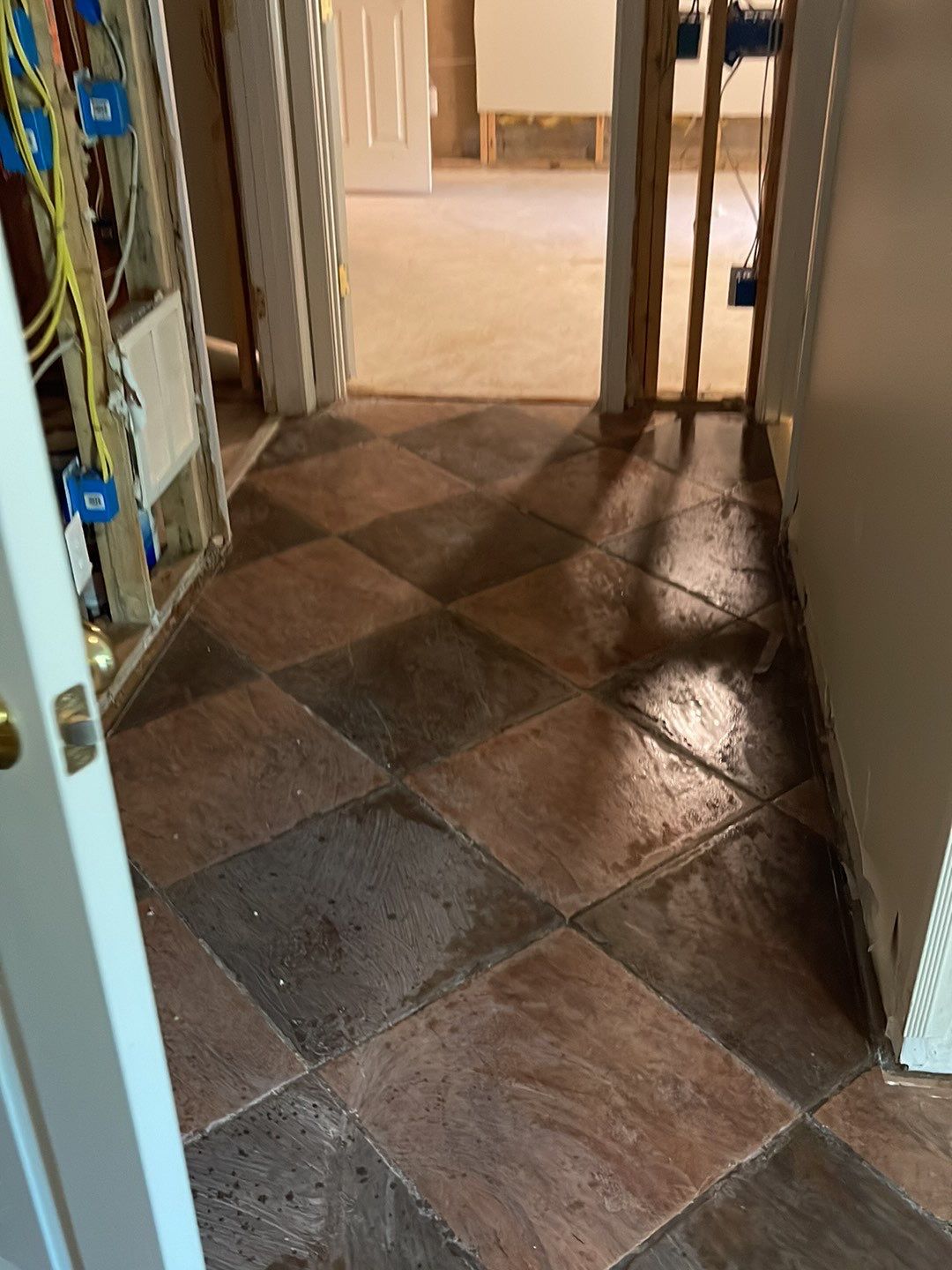 Completed water restoration with new baseboard installed and structural drying phase concluded.