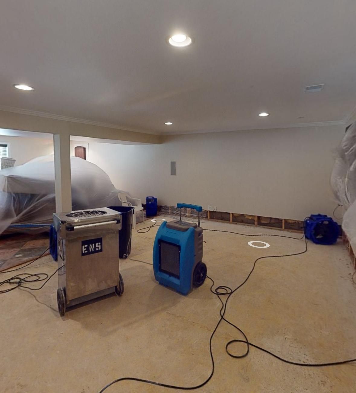 Continued structural drying with dehumidification units monitoring moisture levels in walls and flooring.