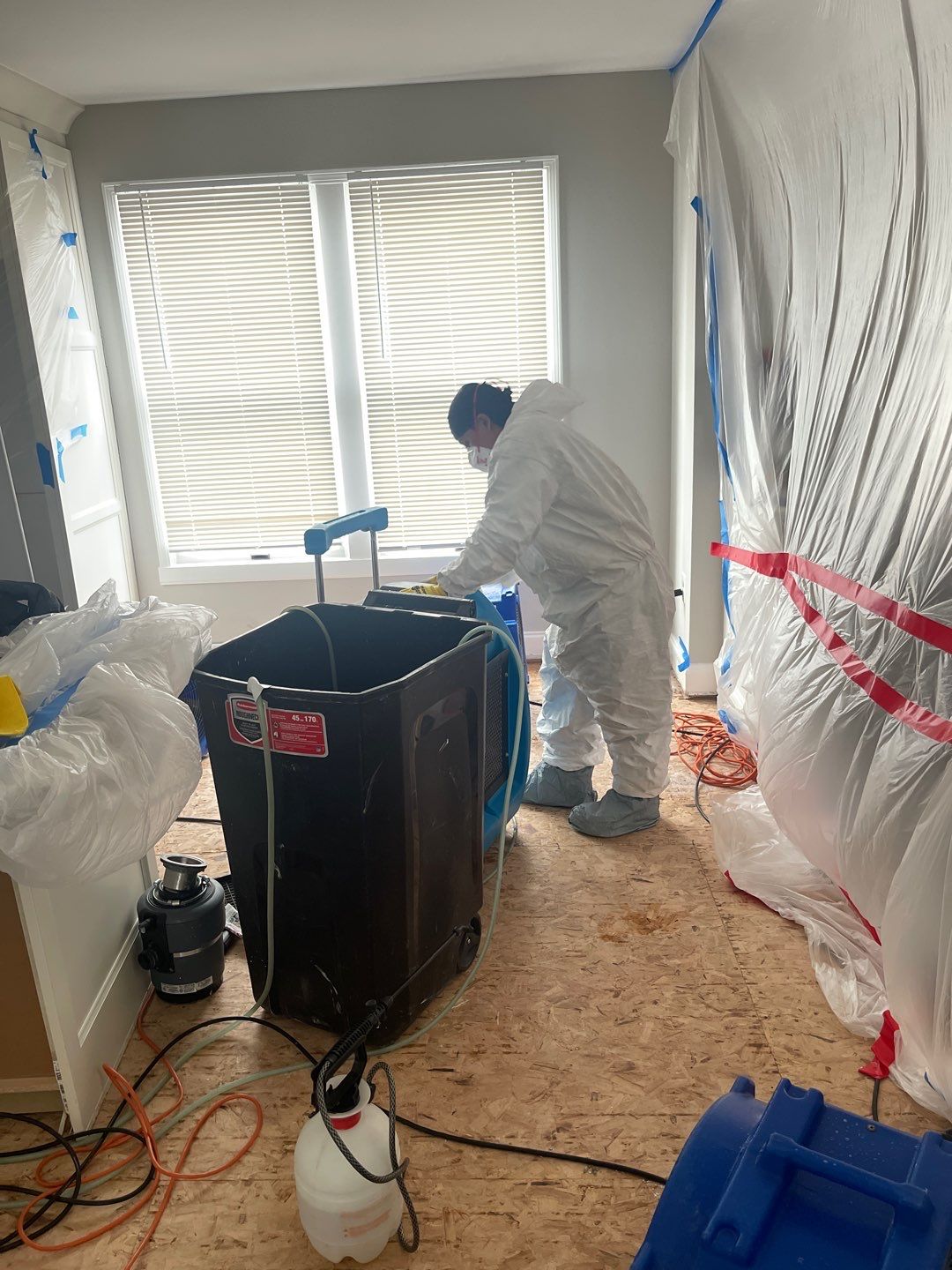Containment barrier and negative air setup during water damage remediation in Arlington.