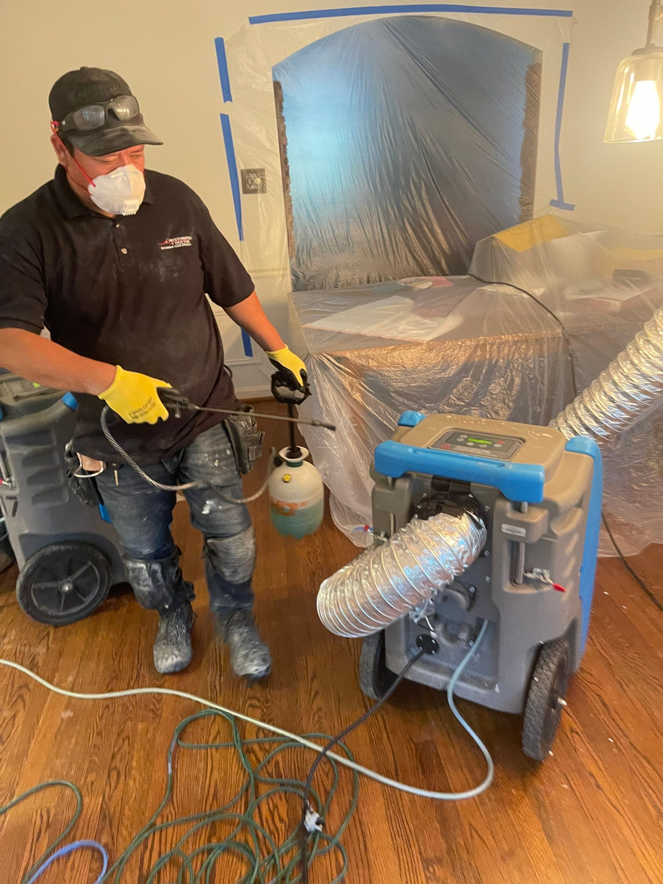 Water damage restoration in McLean showing initial dehumidification and drying equipment deployment in affected room.
