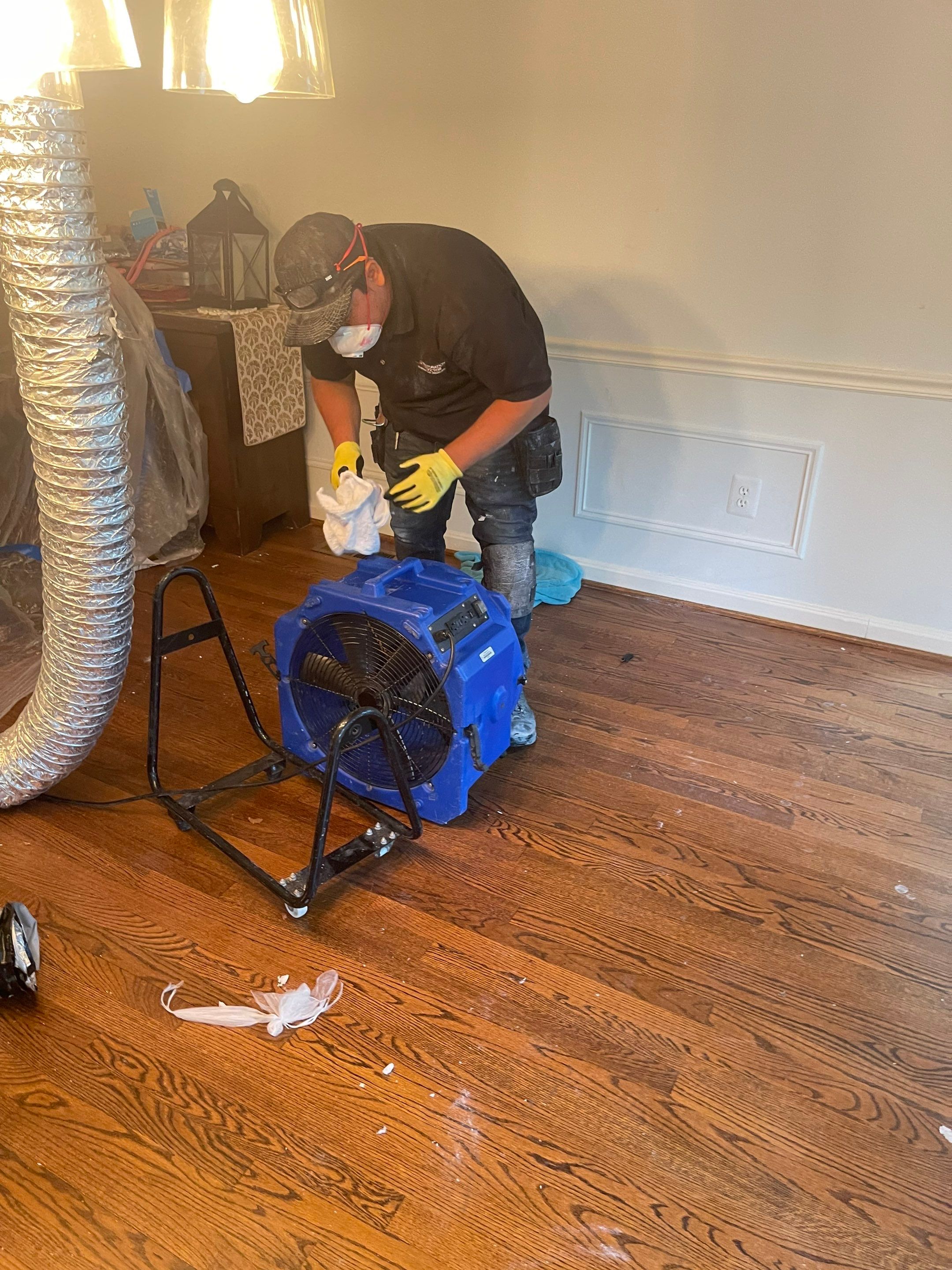 Structural drying in progress with equipment repositioning to address remaining moisture in ceiling and framing.