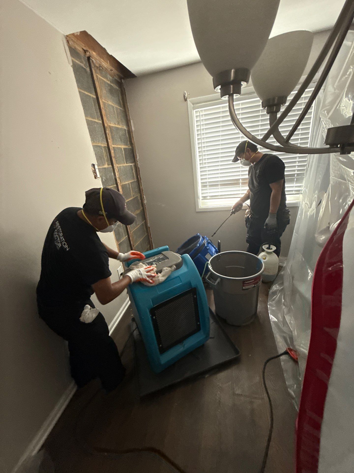 Drying equipment staged throughout interior space, moisture levels being tracked during active restoration.