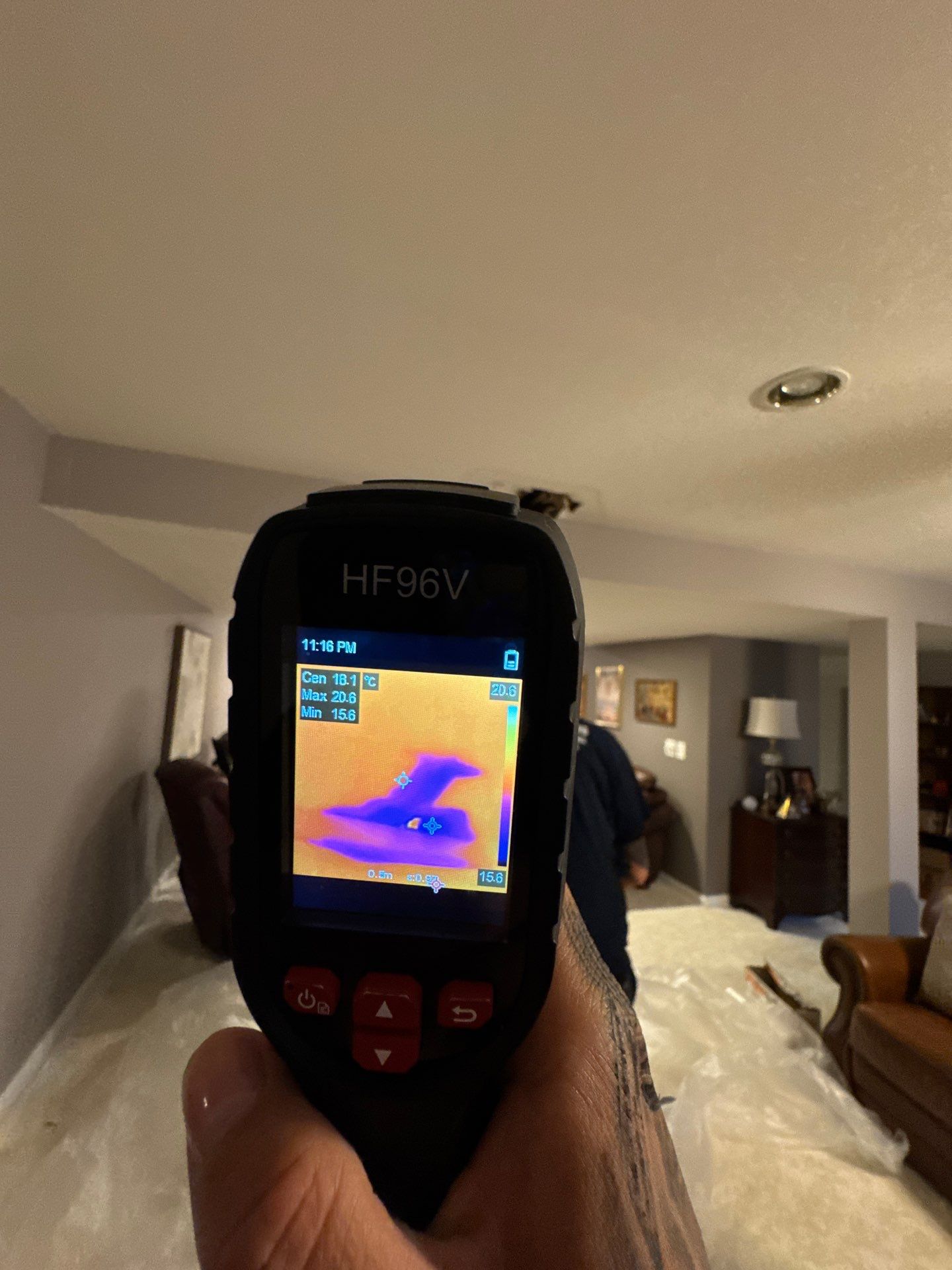 Moisture inspection in progress, thermal data guiding identification of hidden water damage within ceiling cavity.