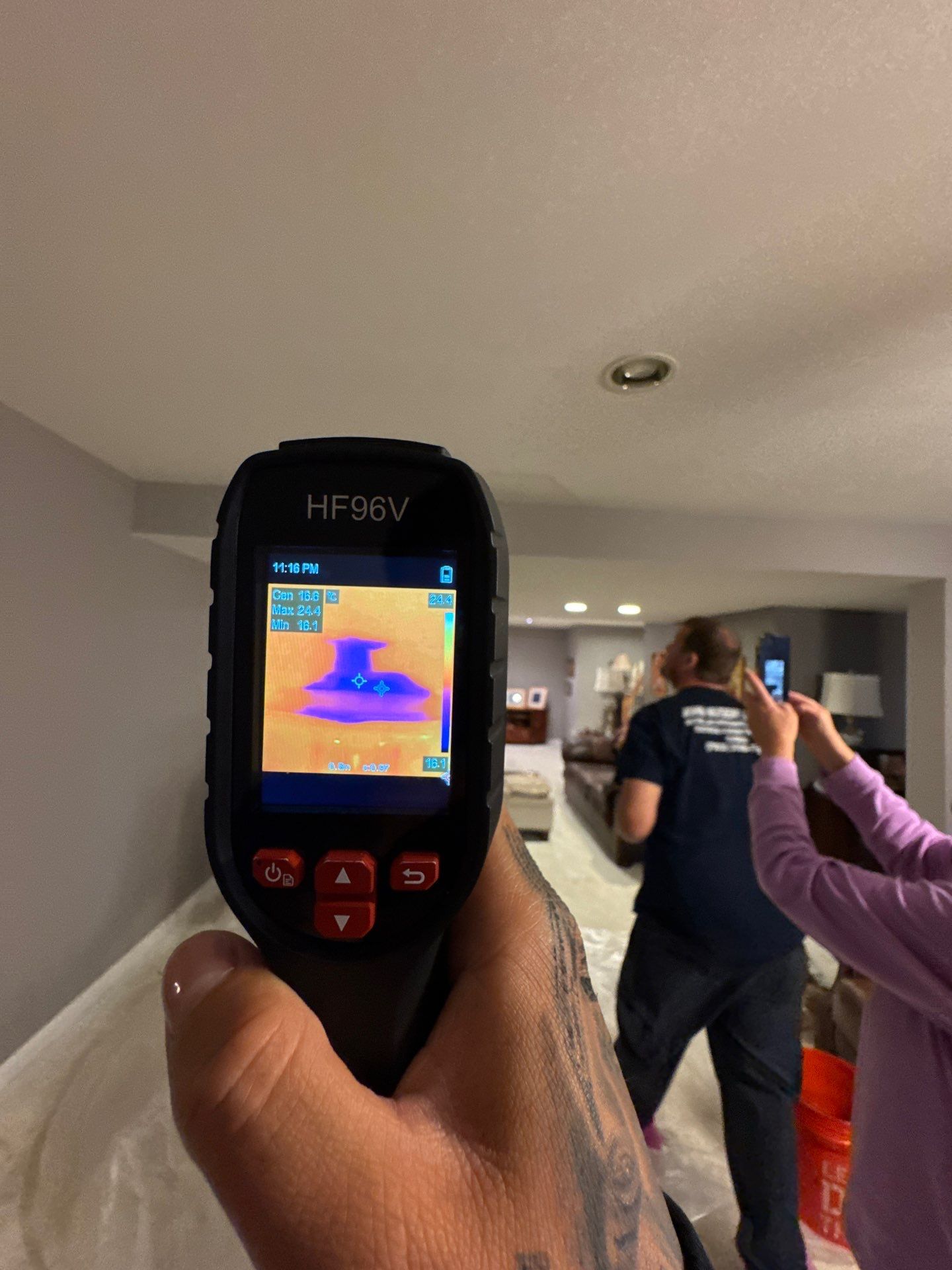 Thermal imaging camera capturing moisture patterns in ceiling assembly during water damage assessment in Ashburn.