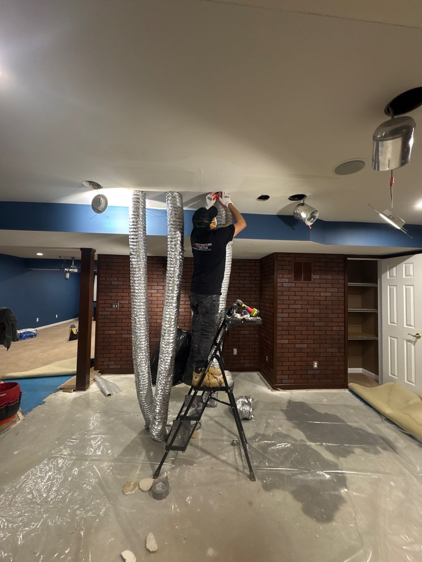 Structural drying equipment positioned to remove residual moisture from affected ceiling assembly.