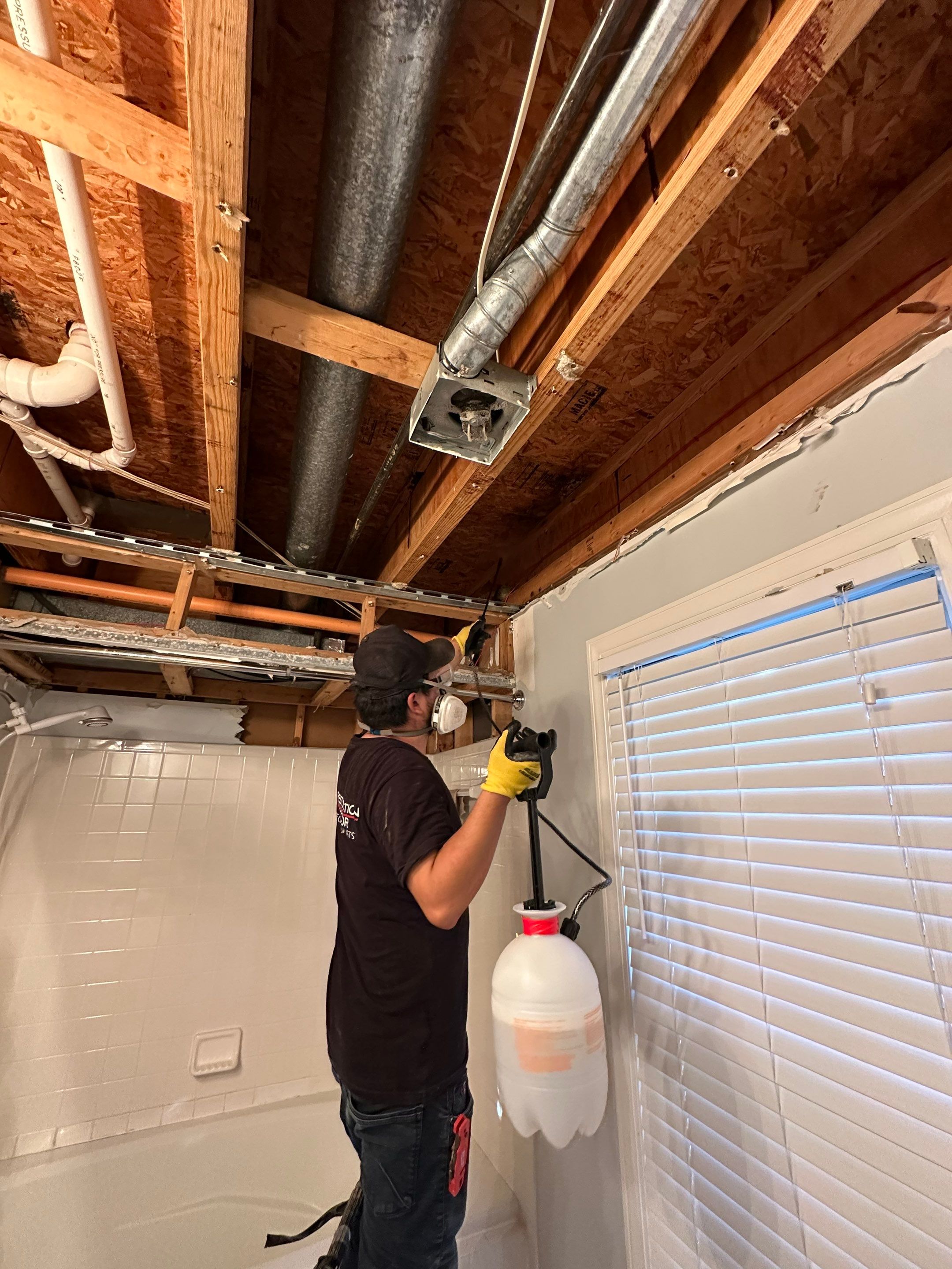 Ceiling damage visible with drying setup continuing; equipment monitors moisture levels throughout the restoration process.