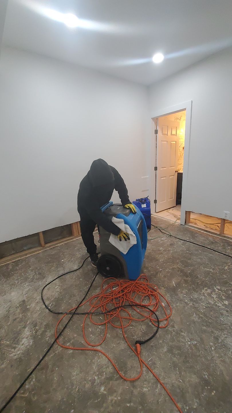 Water extraction and dehumidification equipment positioned in Fairfax home during initial damage assessment and drying phase.