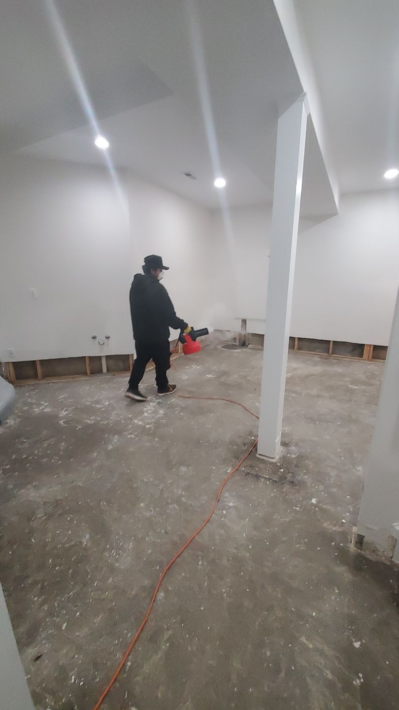 Carpet and flooring remediation underway, with damaged materials staged for removal during water restoration work.