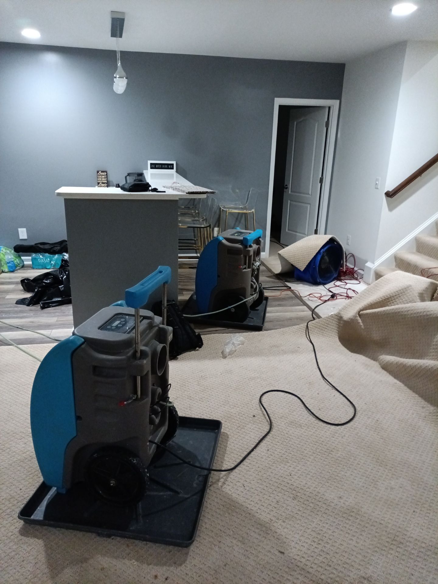 Structural drying equipment positioned to manage moisture in affected areas during water damage restoration.