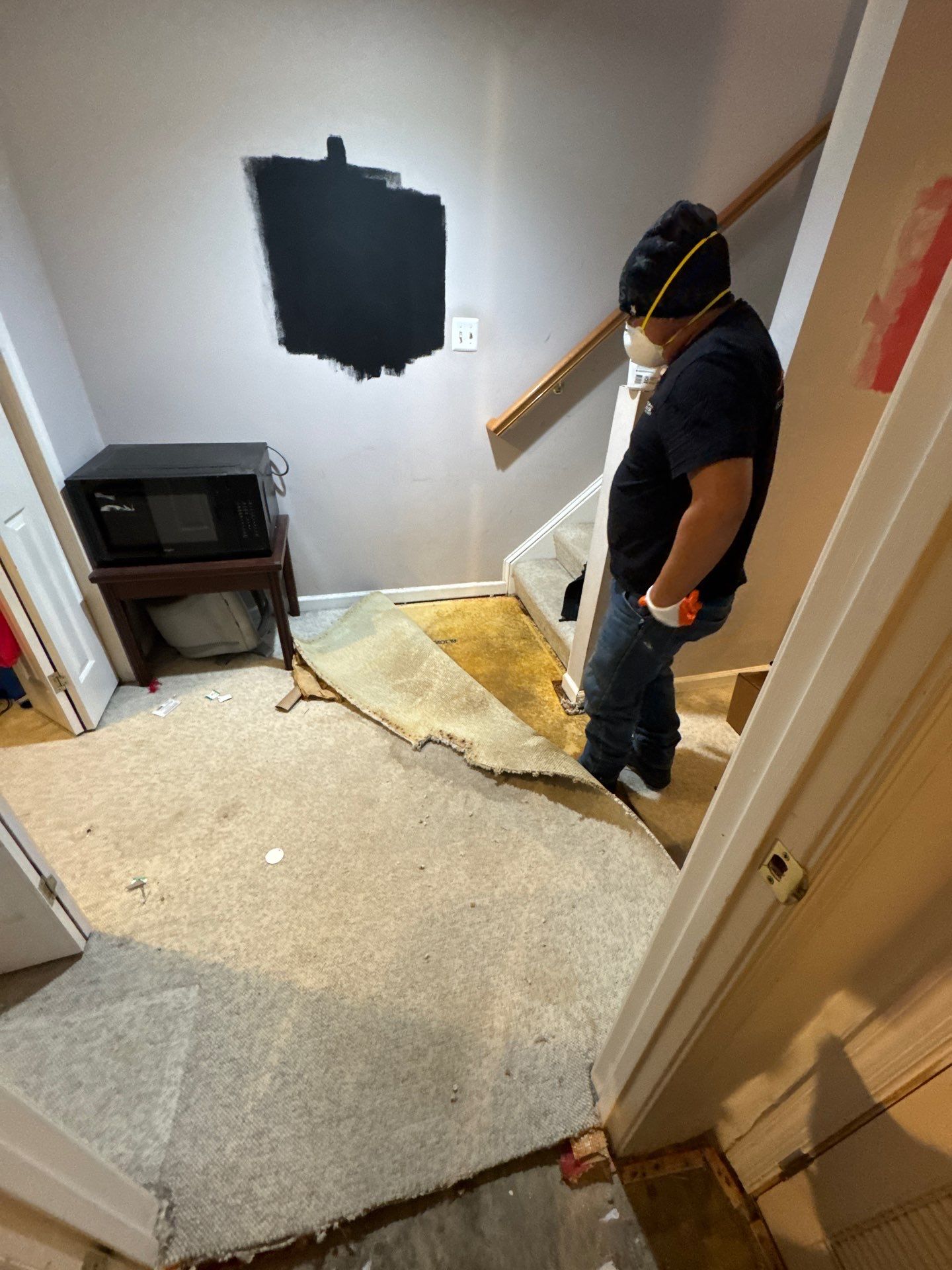 Mid-stage drying process showing dehumidifiers and air movers removing moisture from water-damaged space.