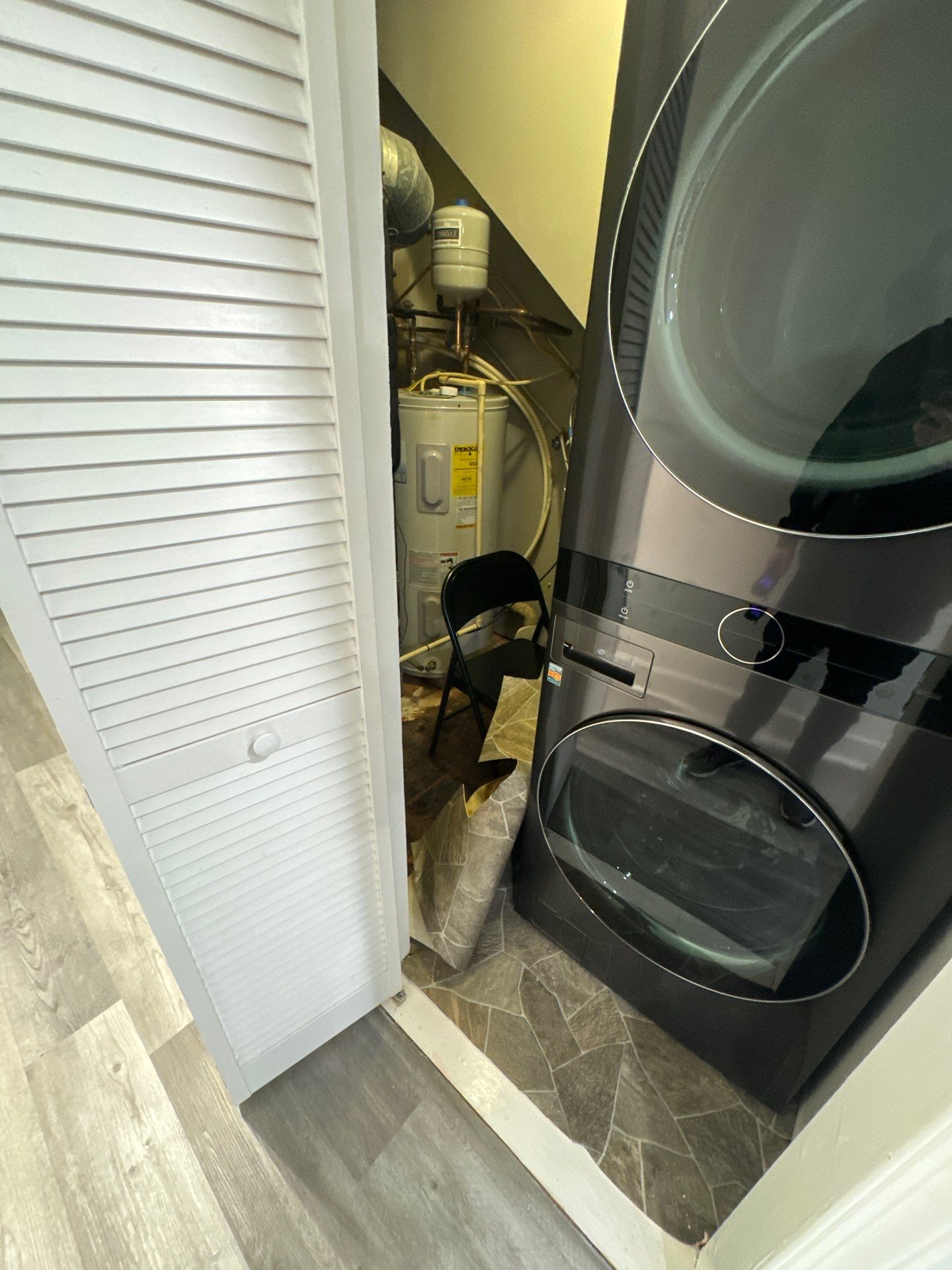 Water damage restoration in Sterling: structural drying equipment positioned in affected space during initial assessment.