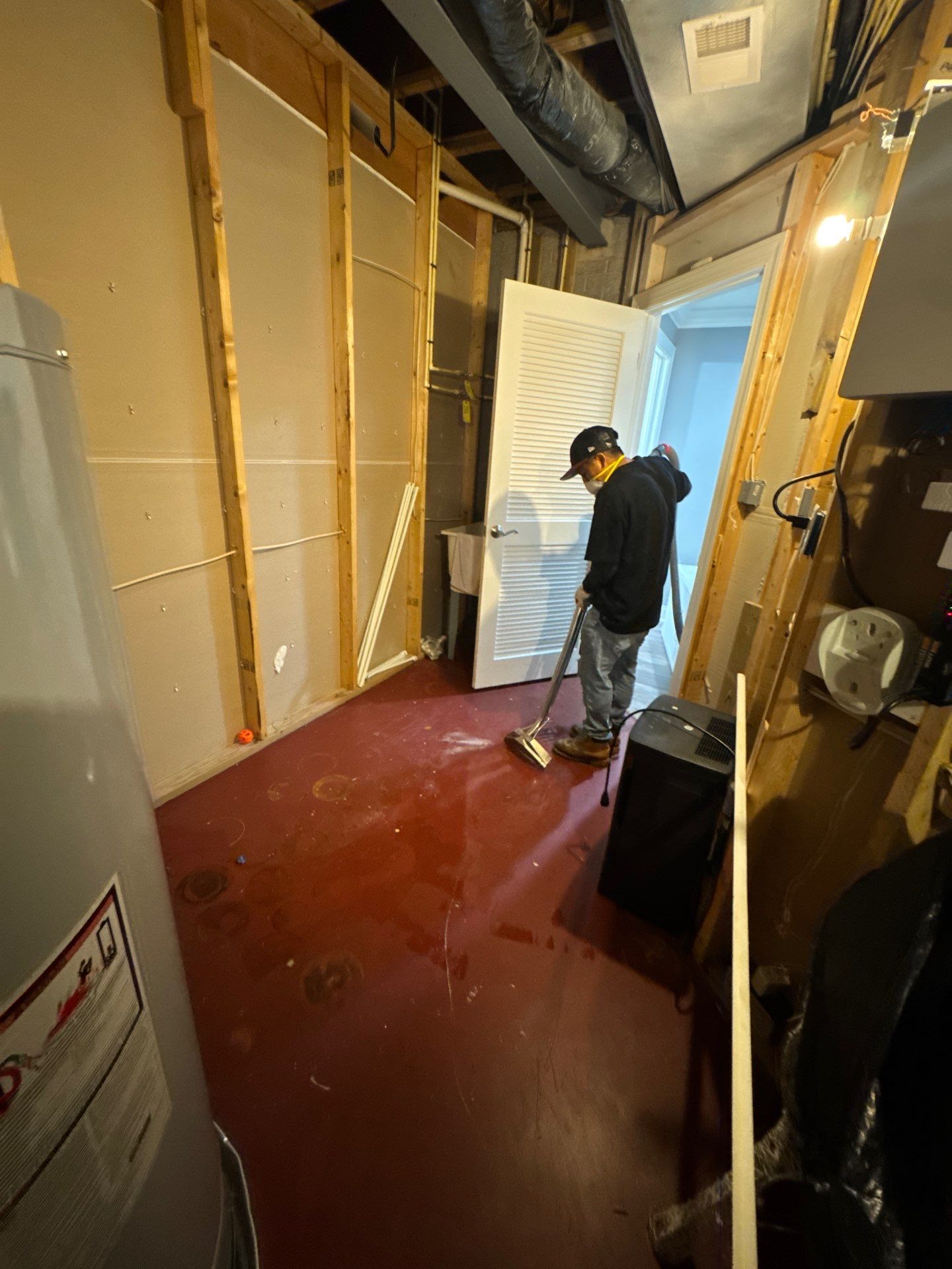 Standing water being extracted from flooded interior during water damage restoration in Fairfax.