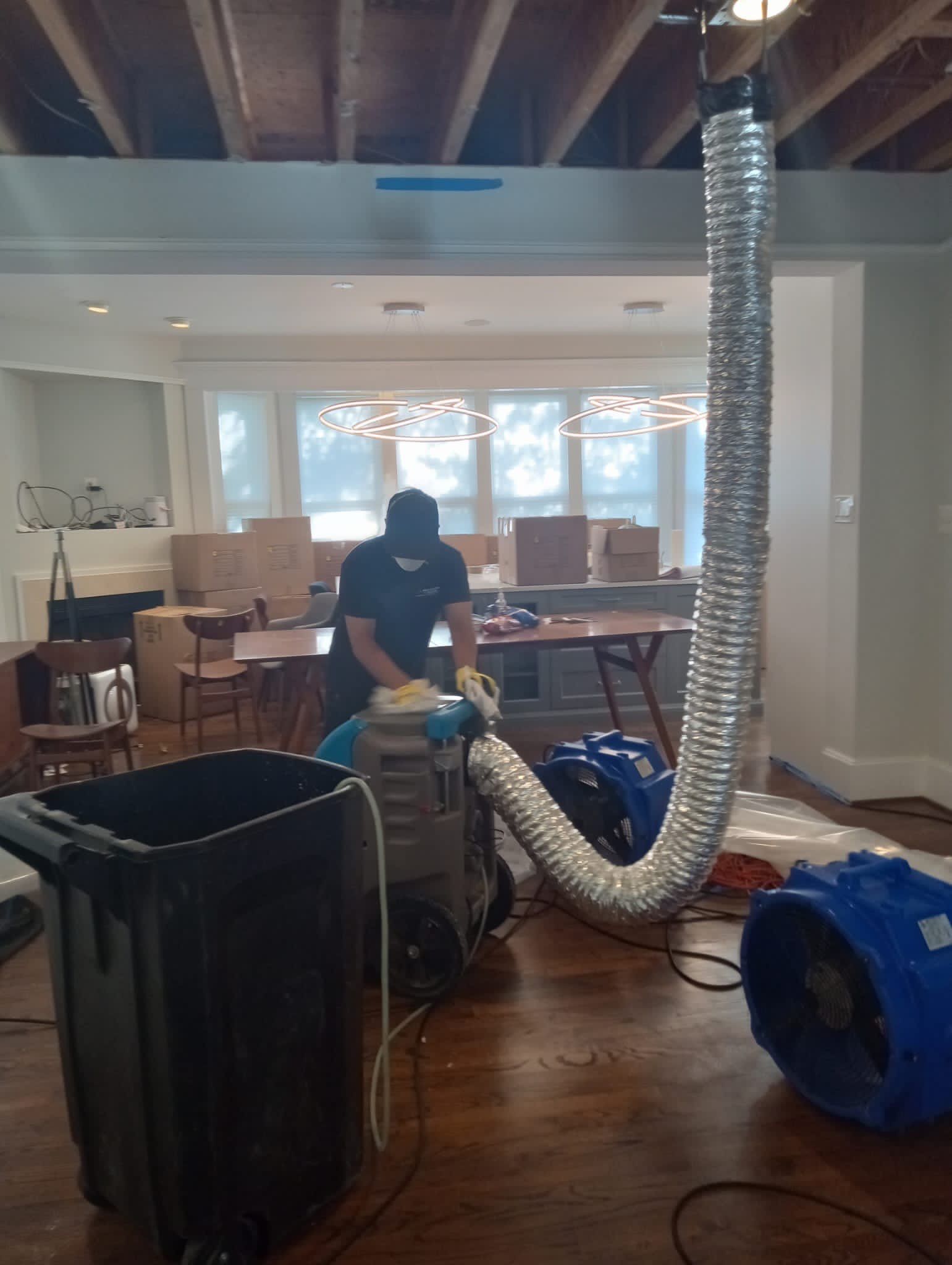 Mid-stage drying process showing dehumidifier placement and moisture extraction during Arlington water restoration.