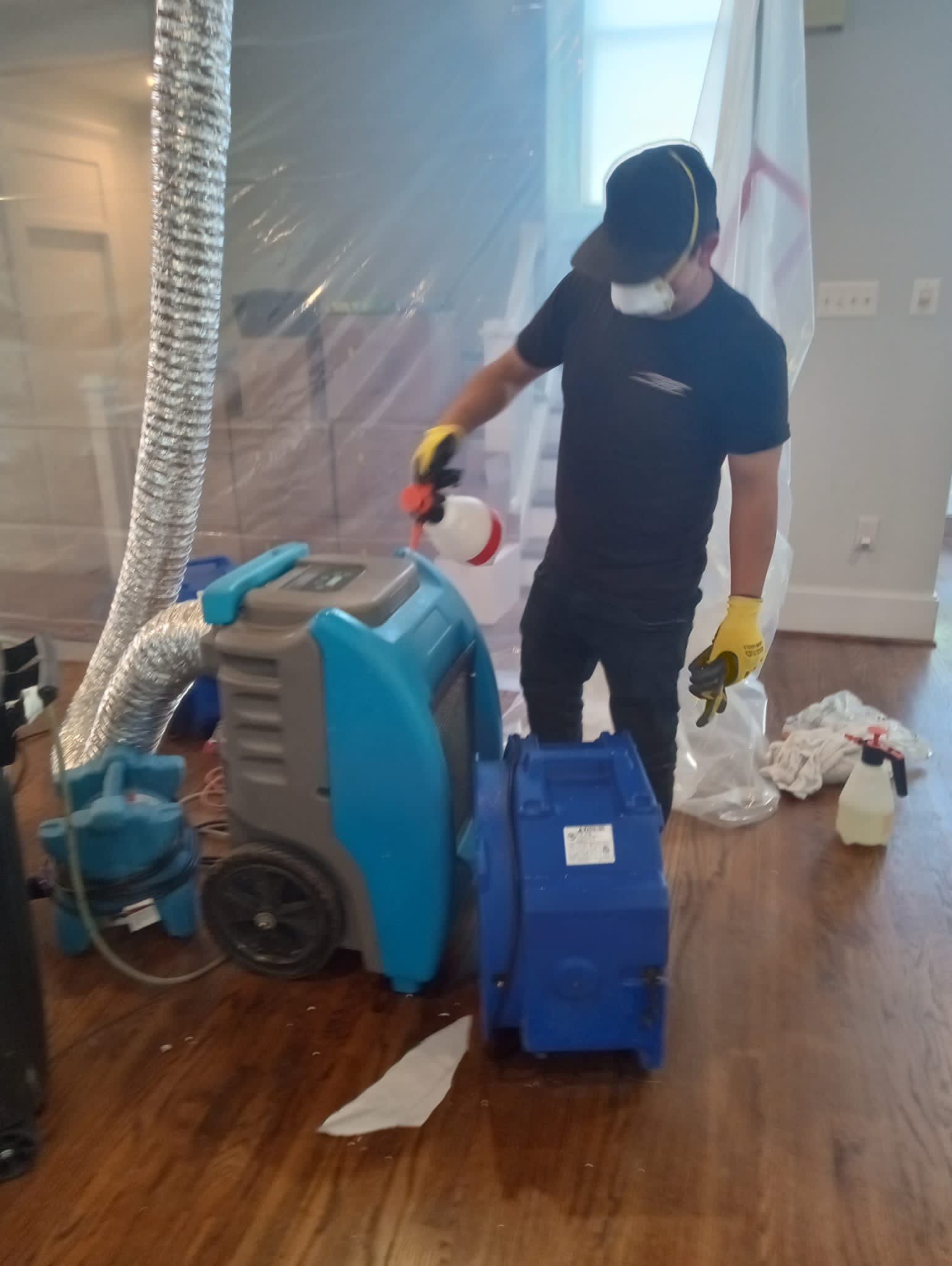 Water damage restoration in Arlington: dehumidification equipment positioned for structural drying after ceiling damage.