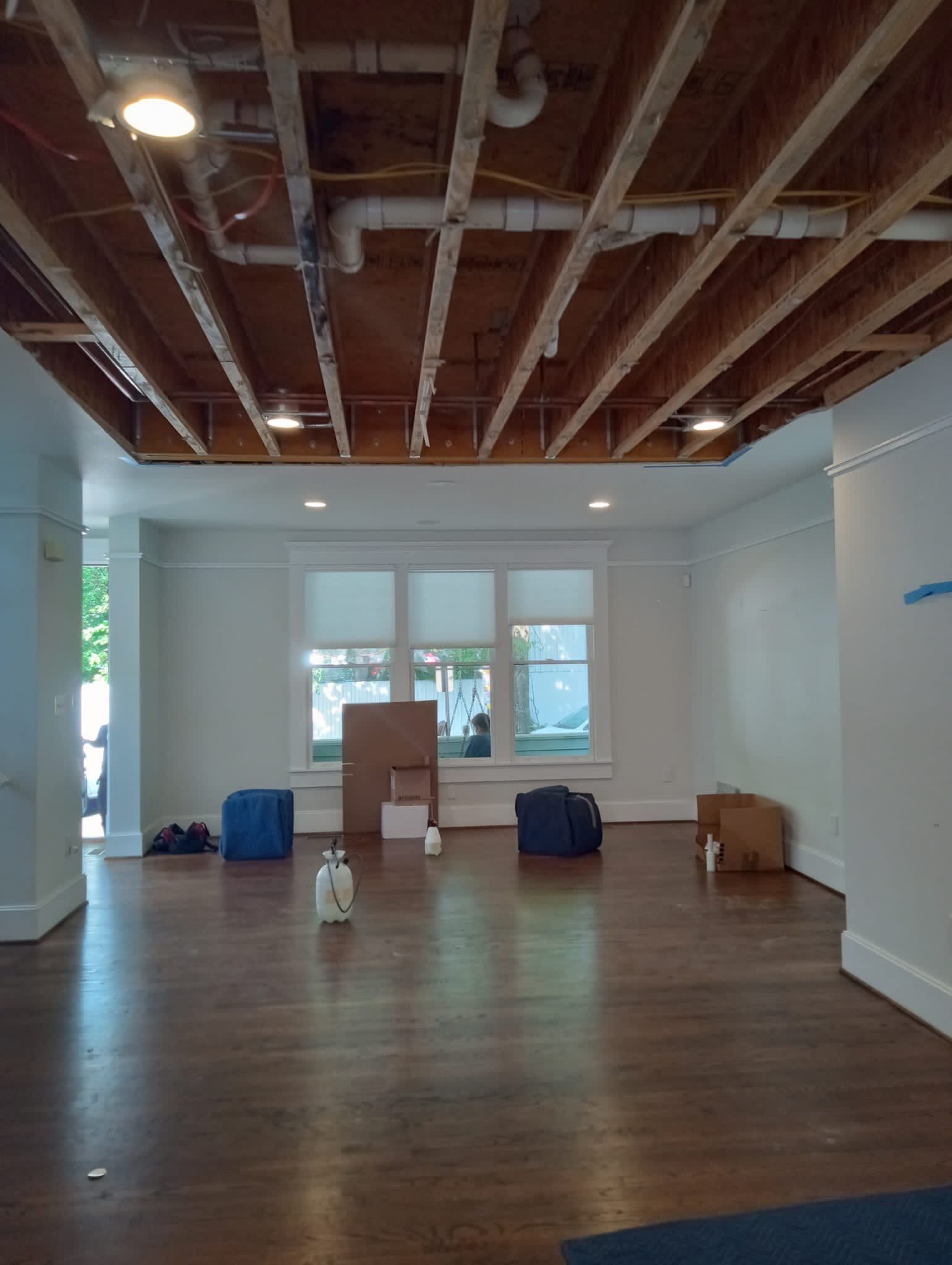 Final-stage structural drying and dehumidification equipment removal following Arlington ceiling repair completion.