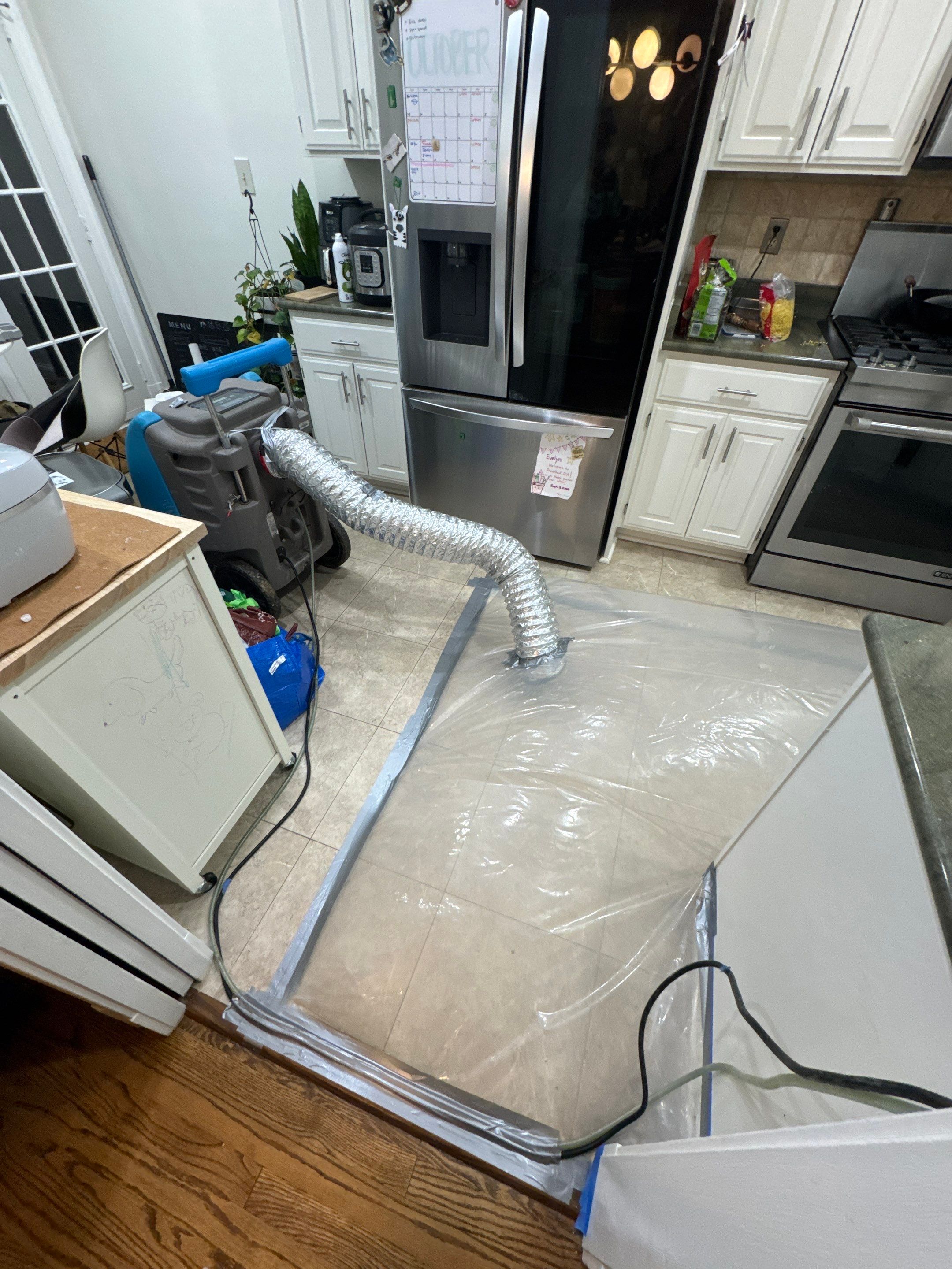 Containment barrier and dehumidification equipment set up during water damage restoration in Vienna.