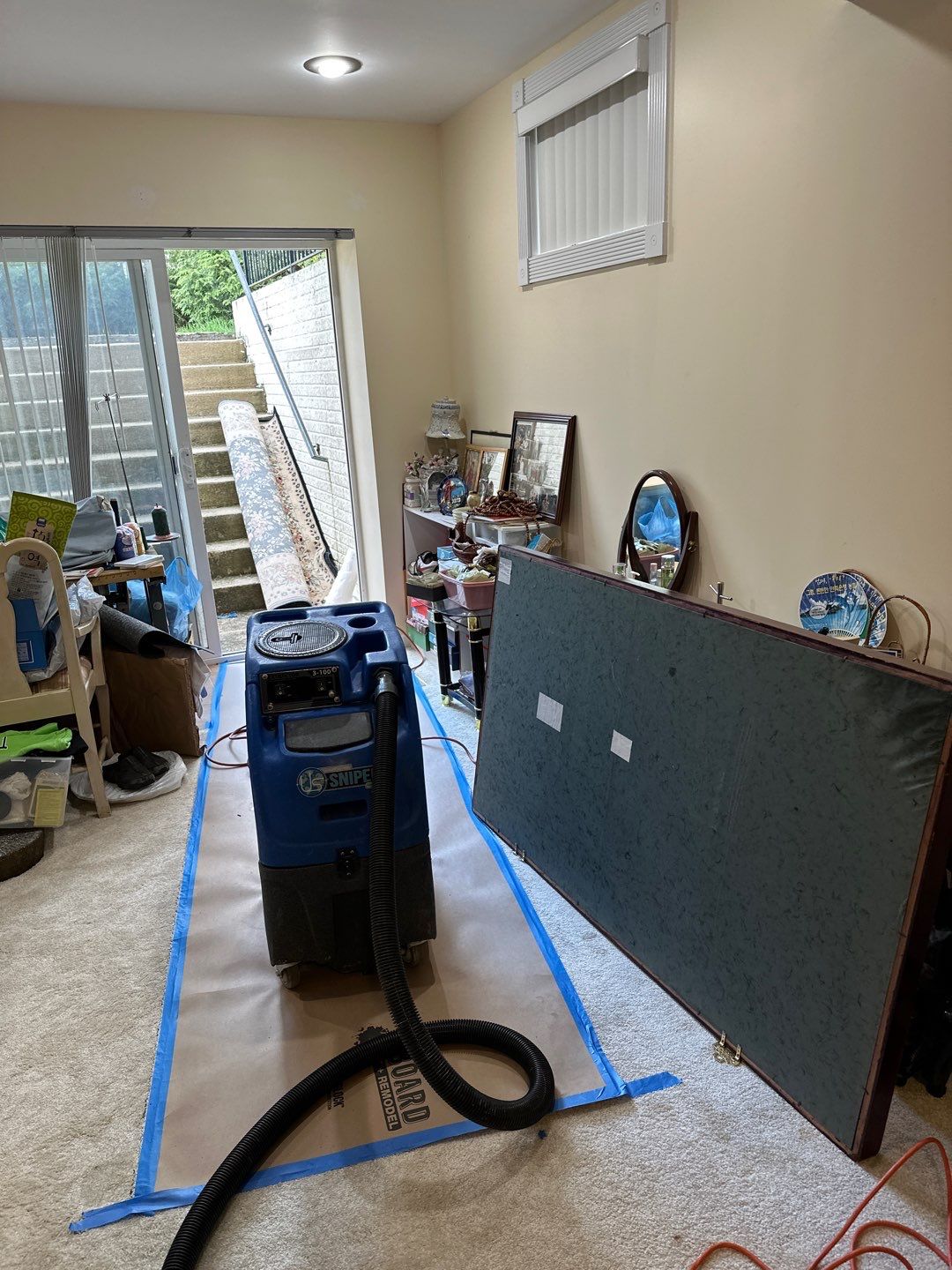Standing water being extracted from flooded interior during water damage restoration in Chantilly.