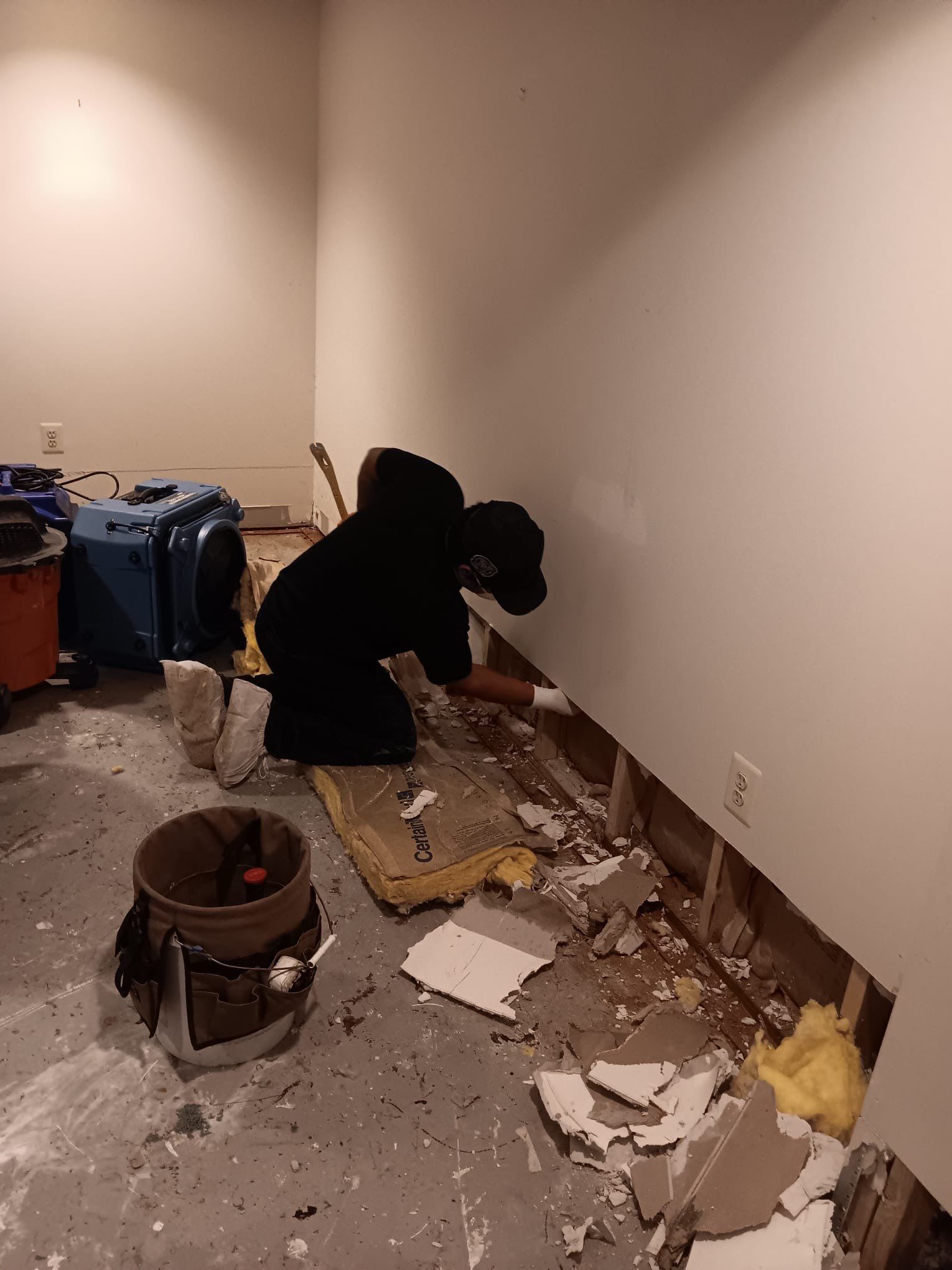 Restored wall section after mold remediation, with new sideboard installed and area dried and sealed.