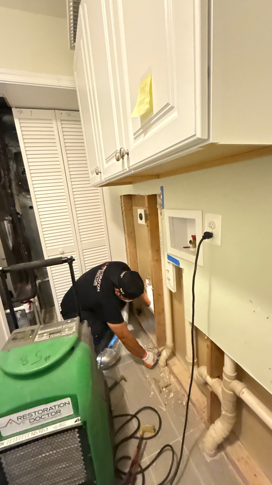 Standing water extraction underway in McLean water damage restoration, removing pooled water from flooring.