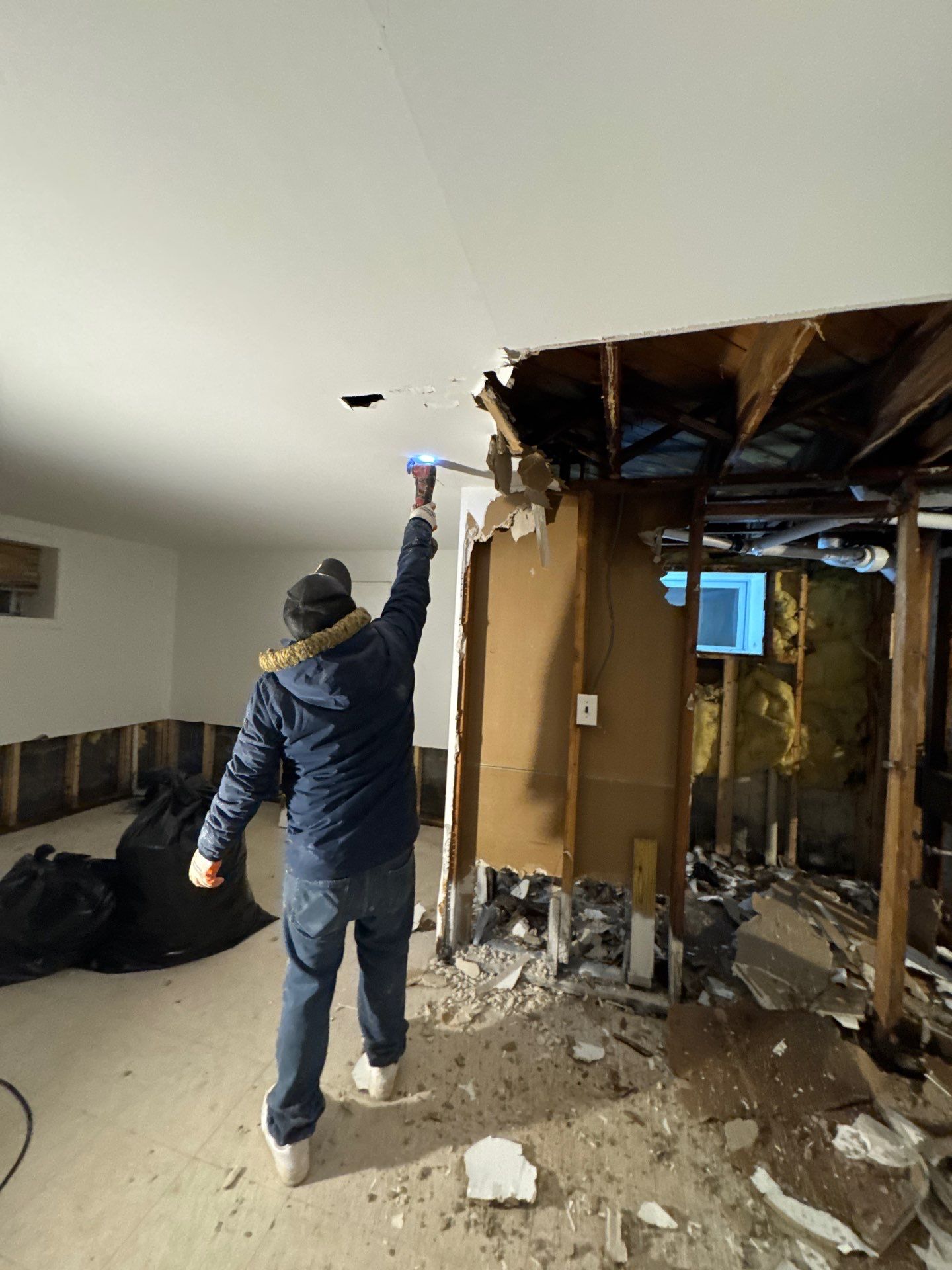Ceiling section removed to expose water-damaged framing and allow thermal moisture mapping to proceed.