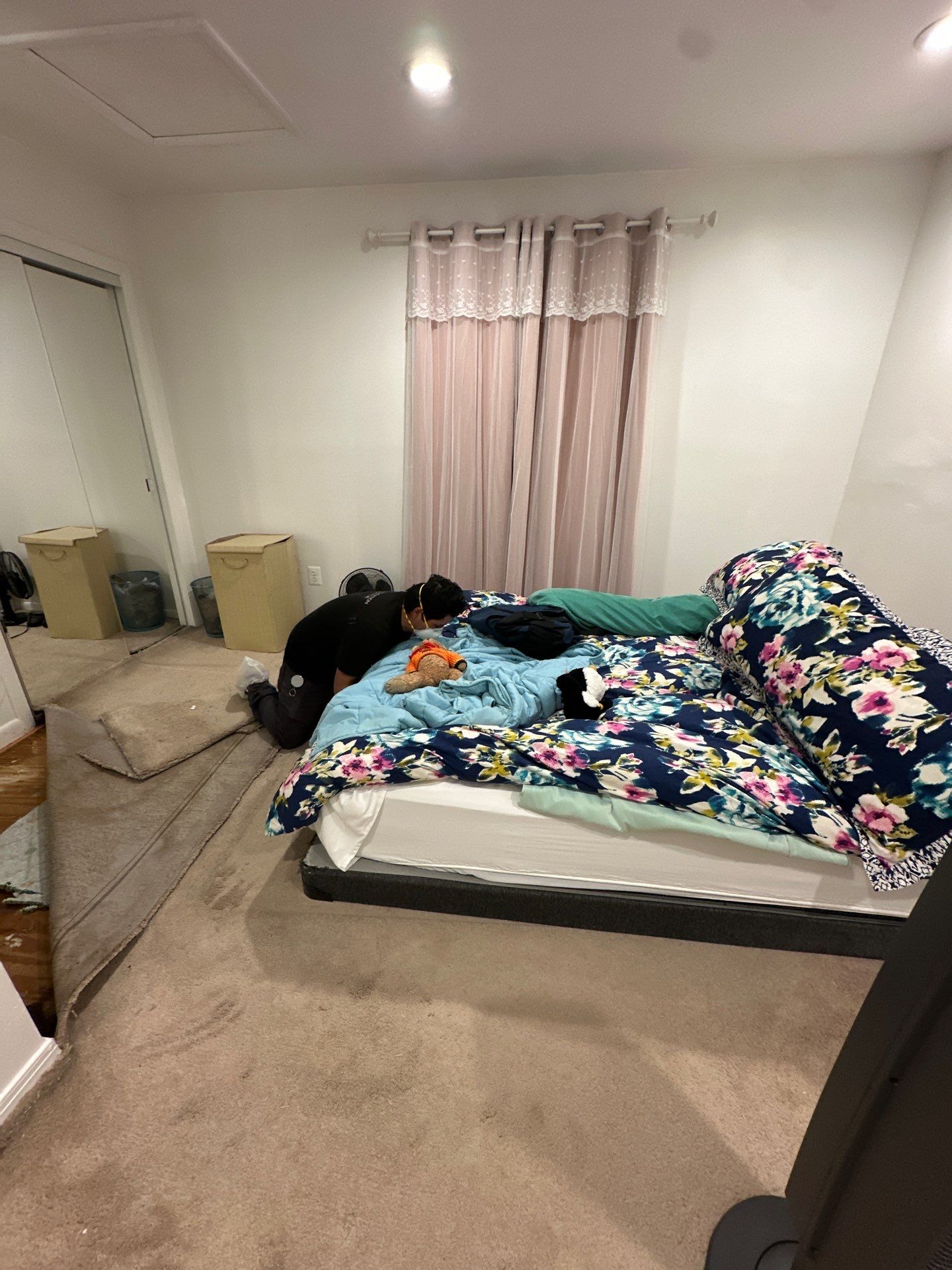 Water damage restoration in Falls Church: initial assessment showing wet flooring and dehumidification equipment setup.