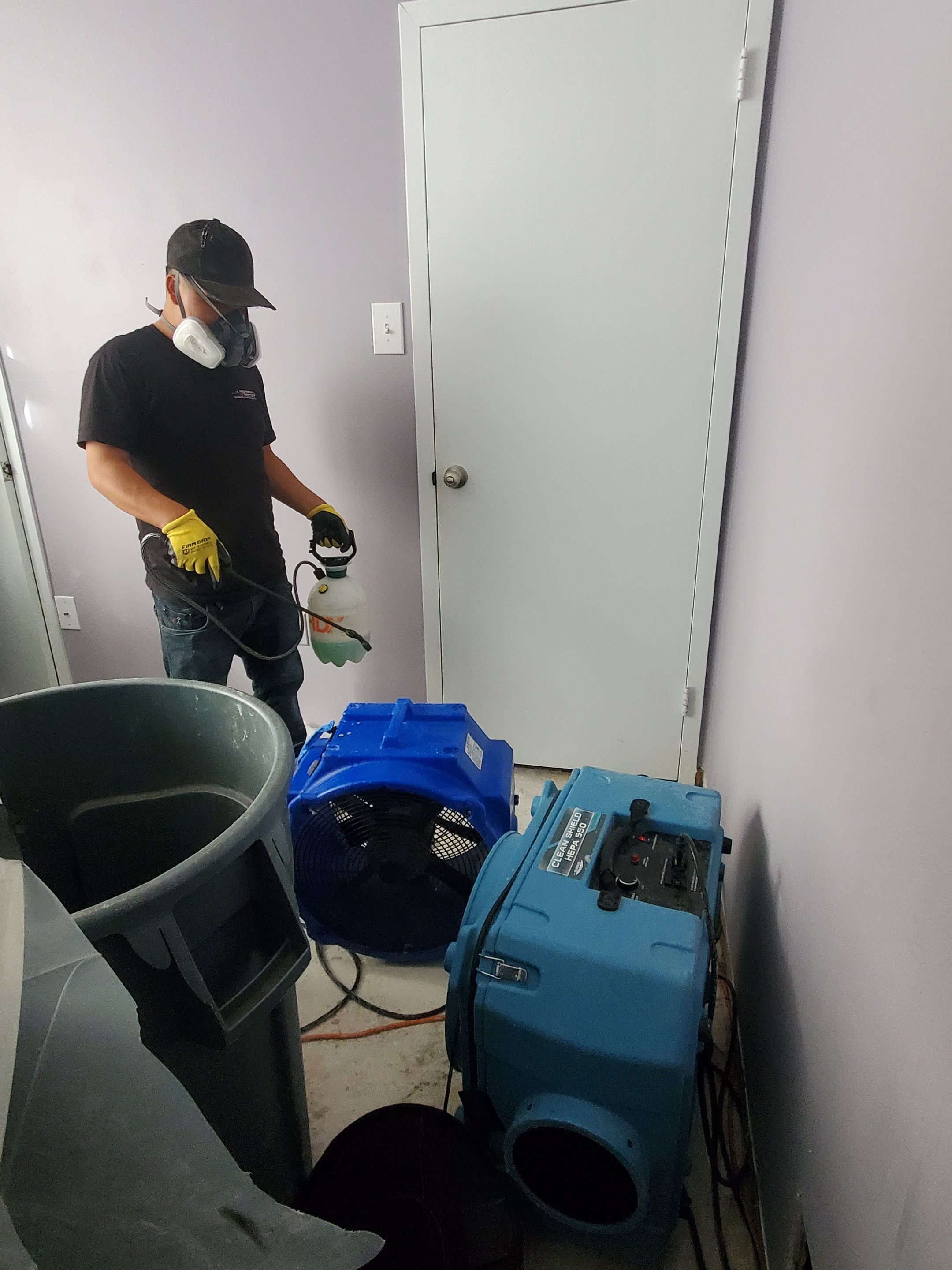 Dehumidification and air movement equipment positioned within containment during Arlington water mitigation.