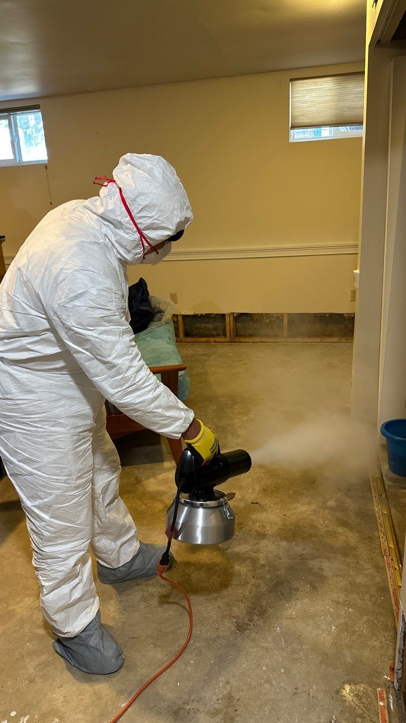 Water-damaged carpet and subflooring in Chantilly home with dehumidification equipment positioned for structural drying.