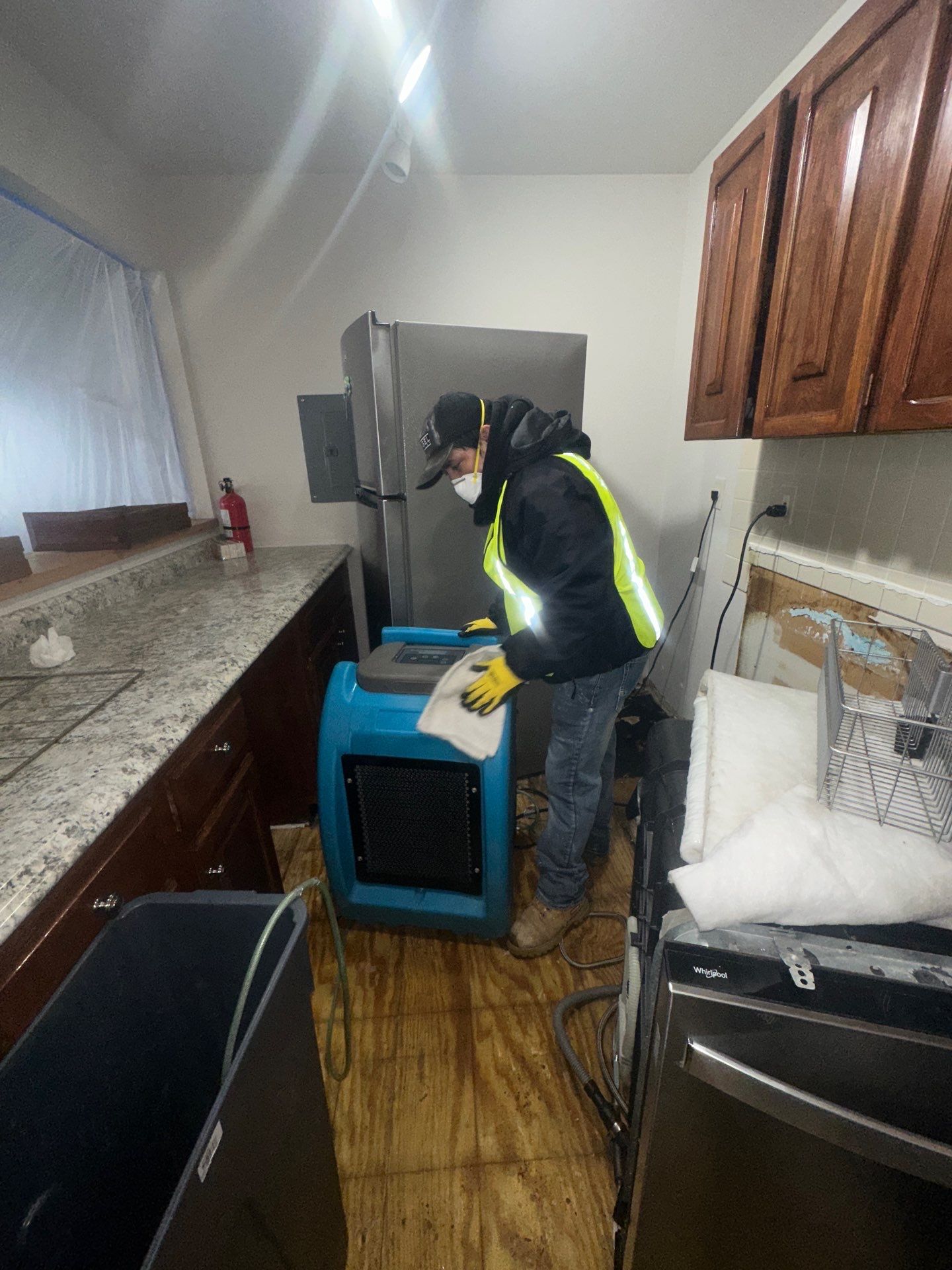 Standing water extraction underway in Falls Church water damage restoration, removing pooled water from affected interior space.